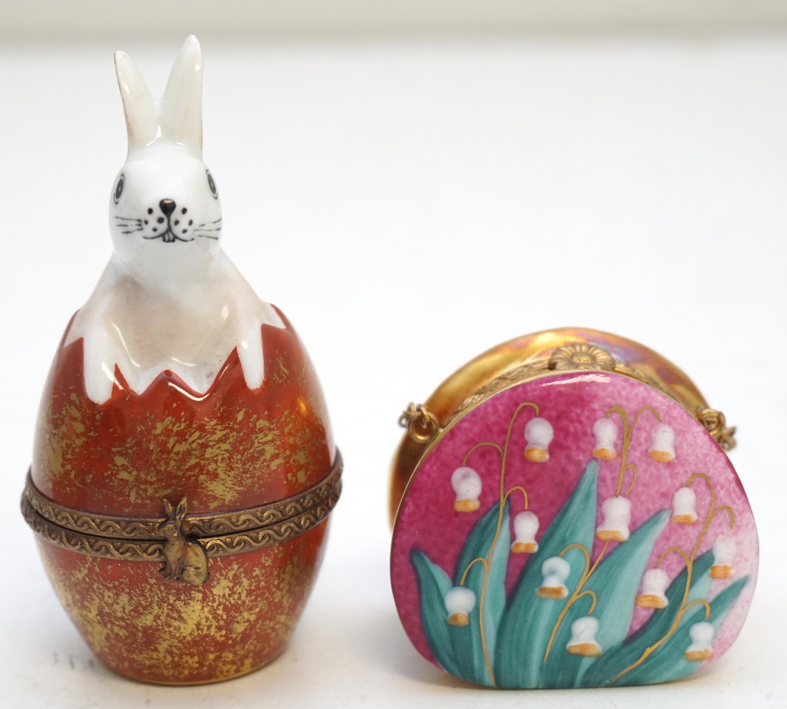 2 LIMOGES PEINT MAIN EASTER BOXES: Two Limoges France Peint Main Christmas Boxes. Rochard Lily of the Valley Decorated Purse 1 1/2". Easter Bunny in Egg 3". Weight 2.4 oz. Good condition. PROVENANCE: A Private Charleston SC Estate