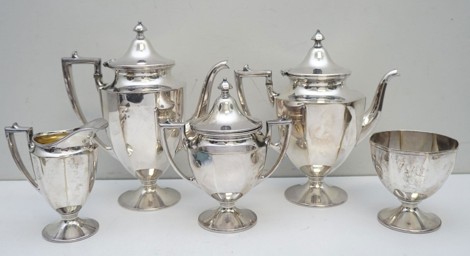 5 PC HOMAN PLATE COFFEE / TEA SERVICE: 5 Pc Homan Plate on Nickel Silver Coffee and Tea Service c. 1920. No monograms. Coffee 10", Tea 9 1/2", Sugar 7 1/2", Creamer 5 1/2". Waste 4". Weight on all 4 pds 5 oz The firm was founded in Cincinn