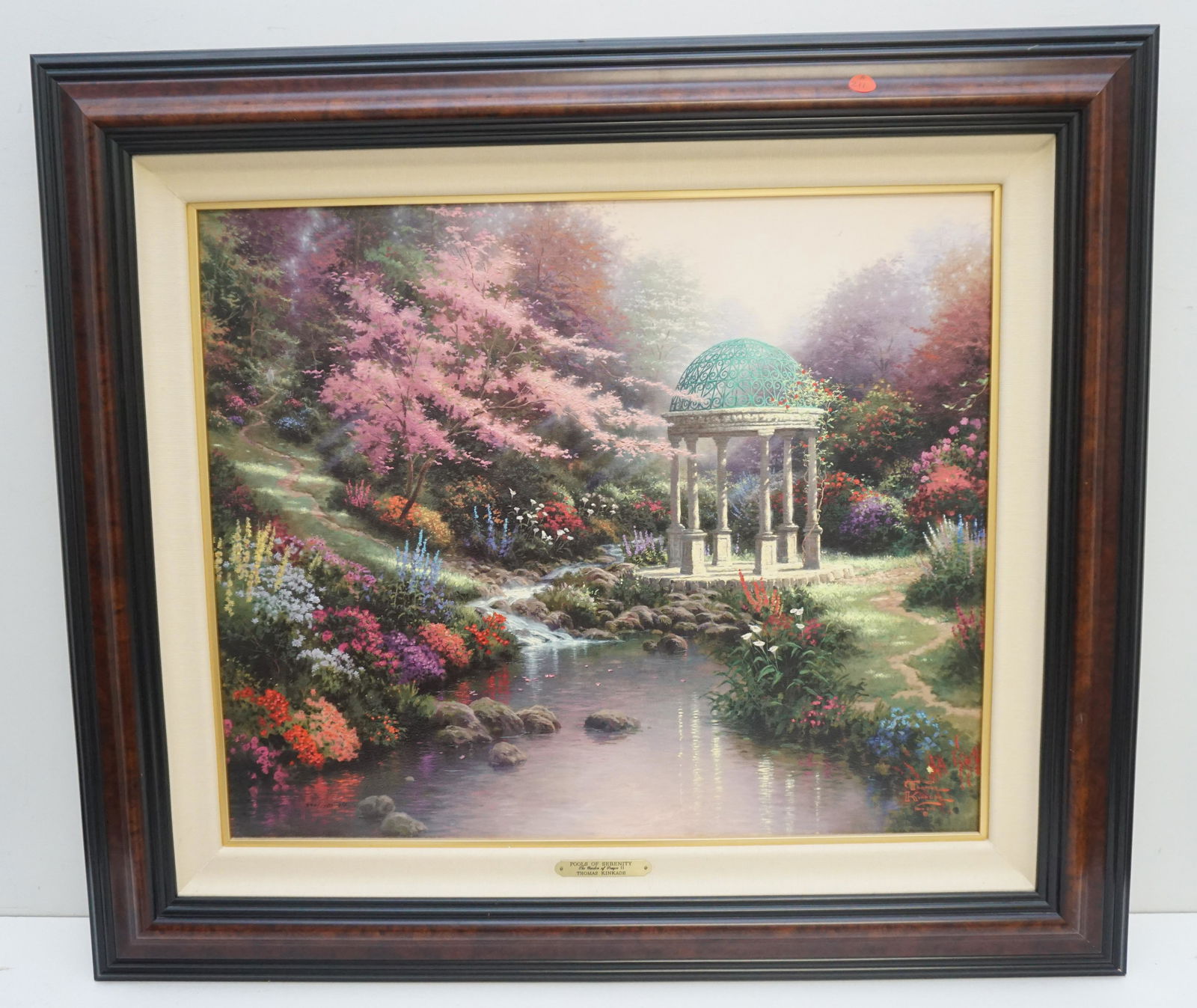THOMAS KINKADE POOL OF SERENITY: Thomas Kinkade Limited Edition 940 of 1750 Print on Canvas "Pool of Serenity". With COA. Gallery Frame with Brass Plaque. Measures 32"x29"x2". Weight 10 pds. PROVENANCE: A Private Charleston SC Estate