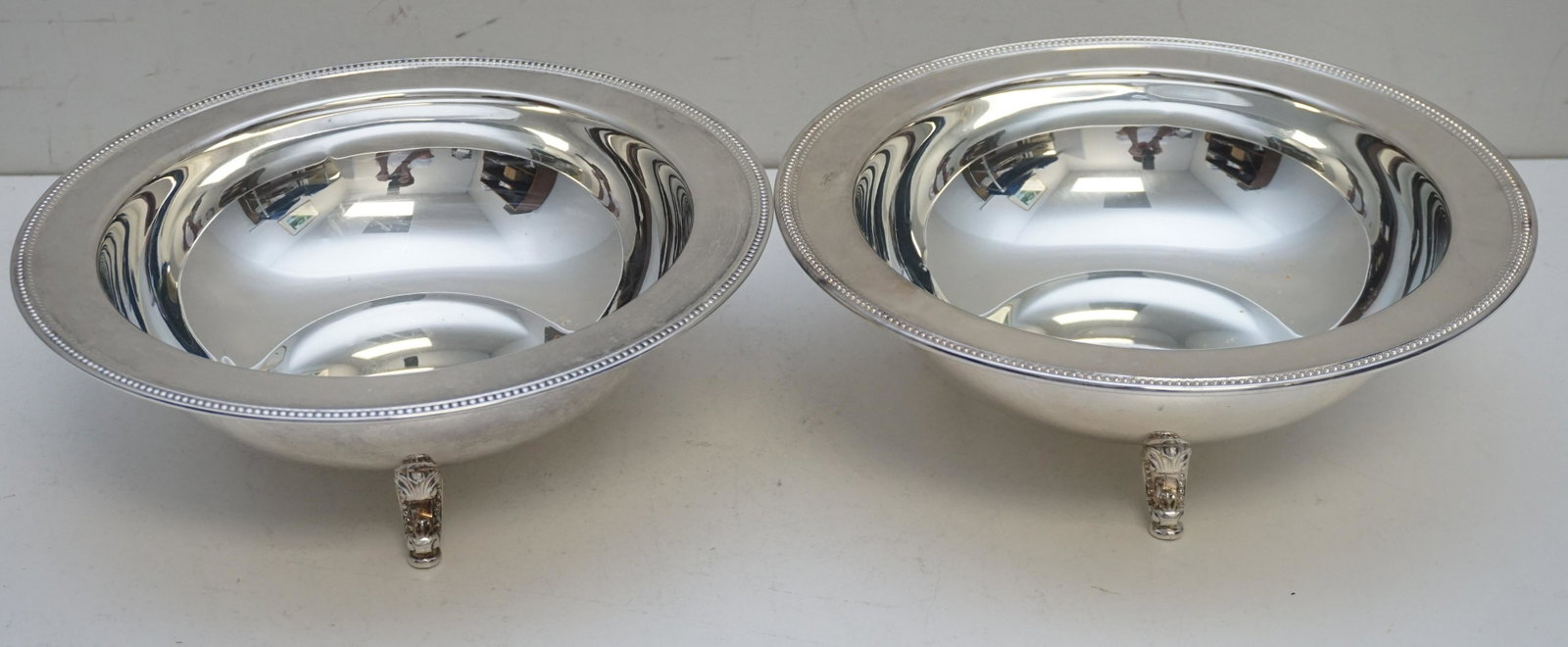 PAIR LARGE SILVERPLATE VEGETABLE BOWLS: Pair of Vintage Oneida Silver Plated Round 3 Footed Vegetable Serving Bowls. Beaded rims on scroll feet. Measures 10 1/4"x10 1/4"x3 1/2". Weight 2 pds 5 oz. PROVENANCE: Edwin Moore Brogdon, PhD, colle