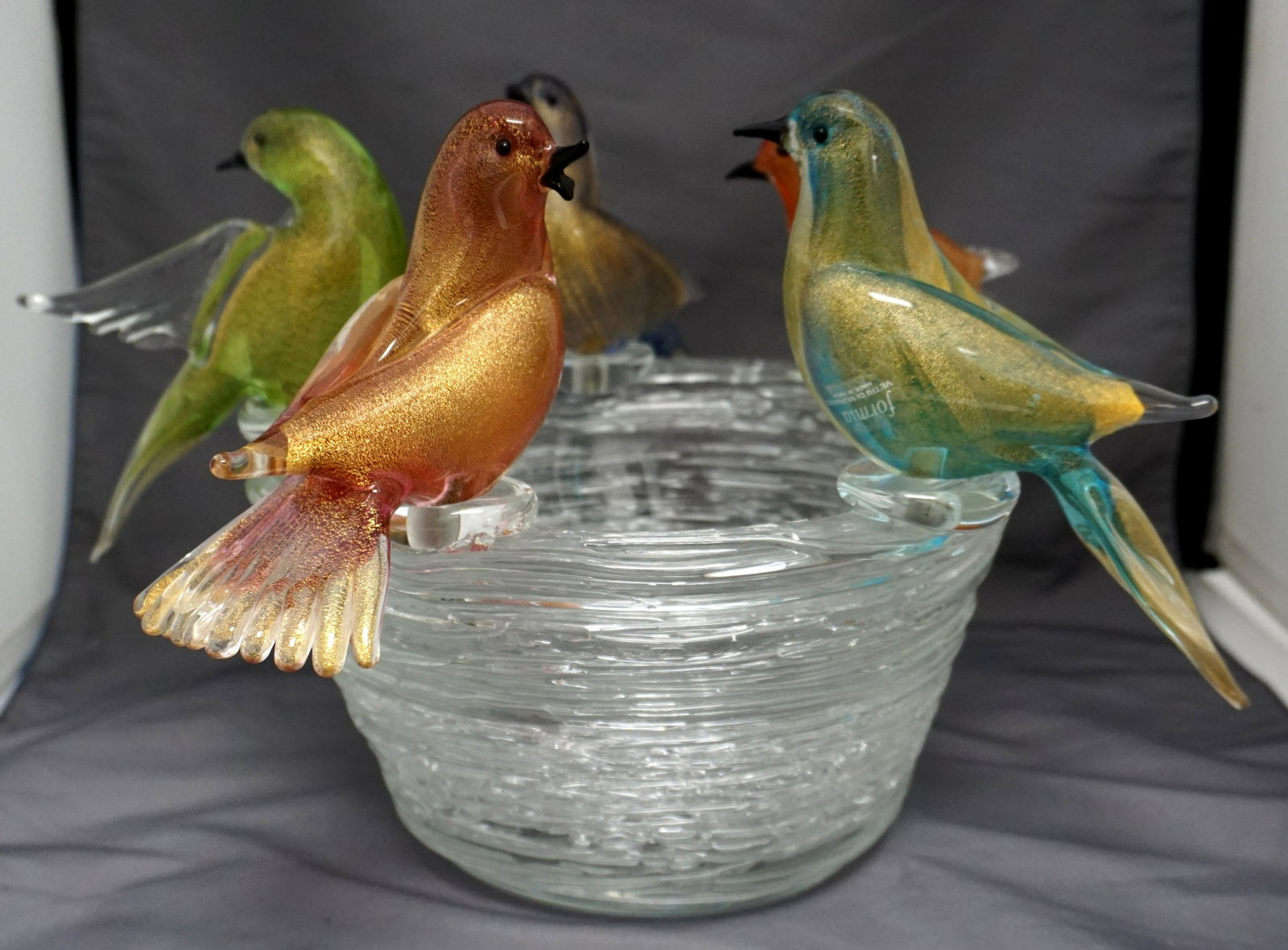 FORMIA MURANO GLASS BIRDBATH: Formia Murano Glass Birdbath. 5 Multicolored Birds perched on clear bowl. One bird with wing and tail damage another with beak damage. PROVENANCE: A Private Charleston SC Estate. ***Pickup only or Shi
