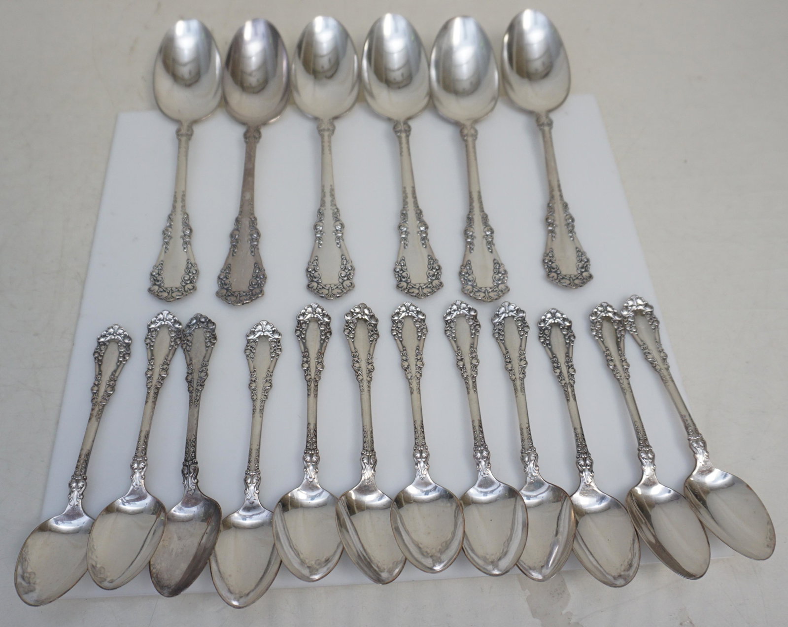 18 pc VICTORIAN TRIPLE PLATED SPOONS: Eighteen Victorian Rogers Bros Triple Plated Spoons in the Berkshire pattern c. 1897. All in good condition. 6 Serving Spoons 8 1/4" and 12 Teaspoons 6". Weight 1 pd 9 oz. PROVENANCE: Edwin Moore Brog