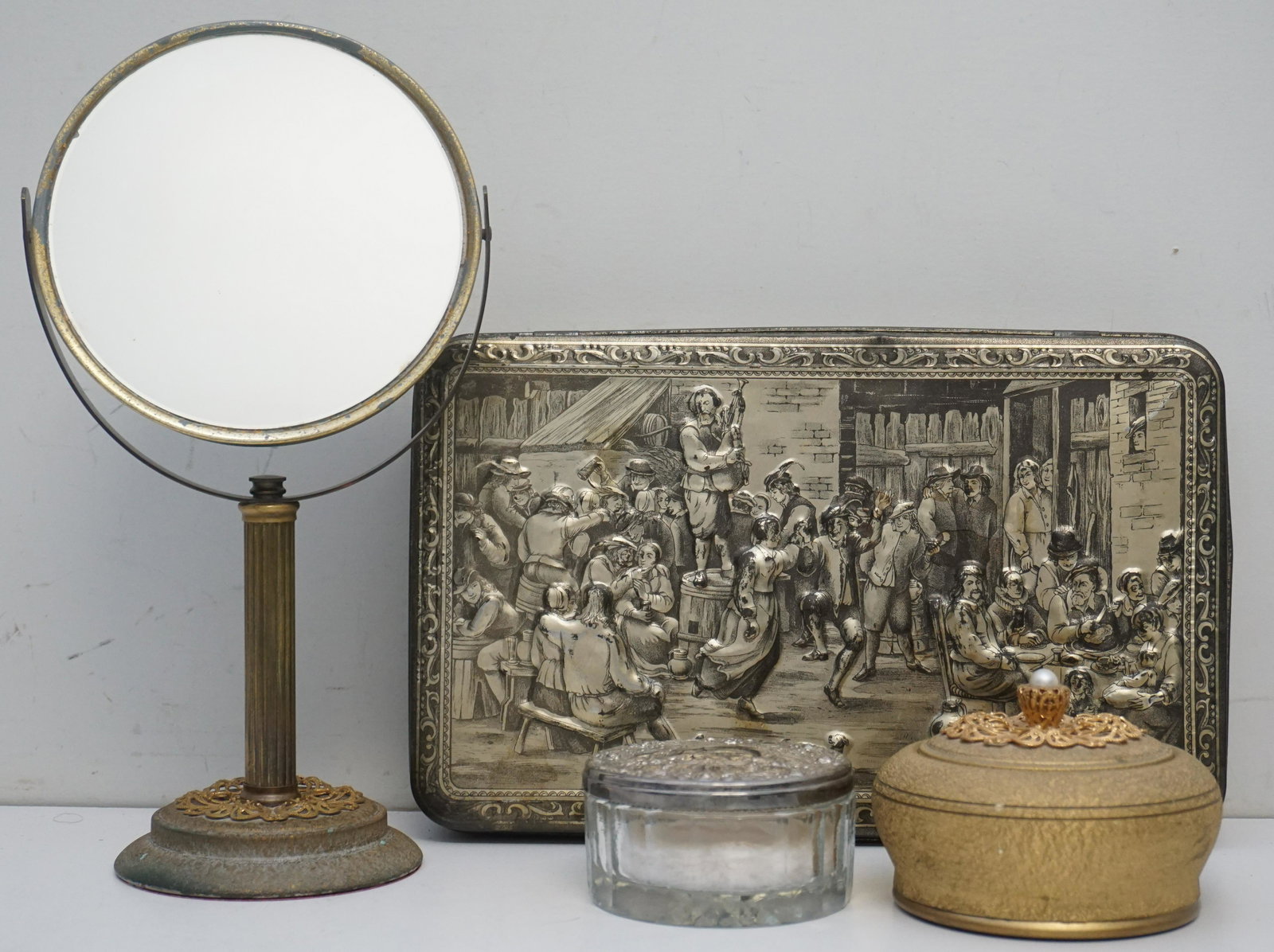 4 PC VINTAGE VANITY MIRROR - POWDER: Vintage Vanity Accessories. International Silverplate and glass powder box with mirrored lid, monogrammed, 3 3/4". Music Box Vanity Mirror 12 1/2" and Powder Box 4", neither work. Cookie Tin Dutch 13"