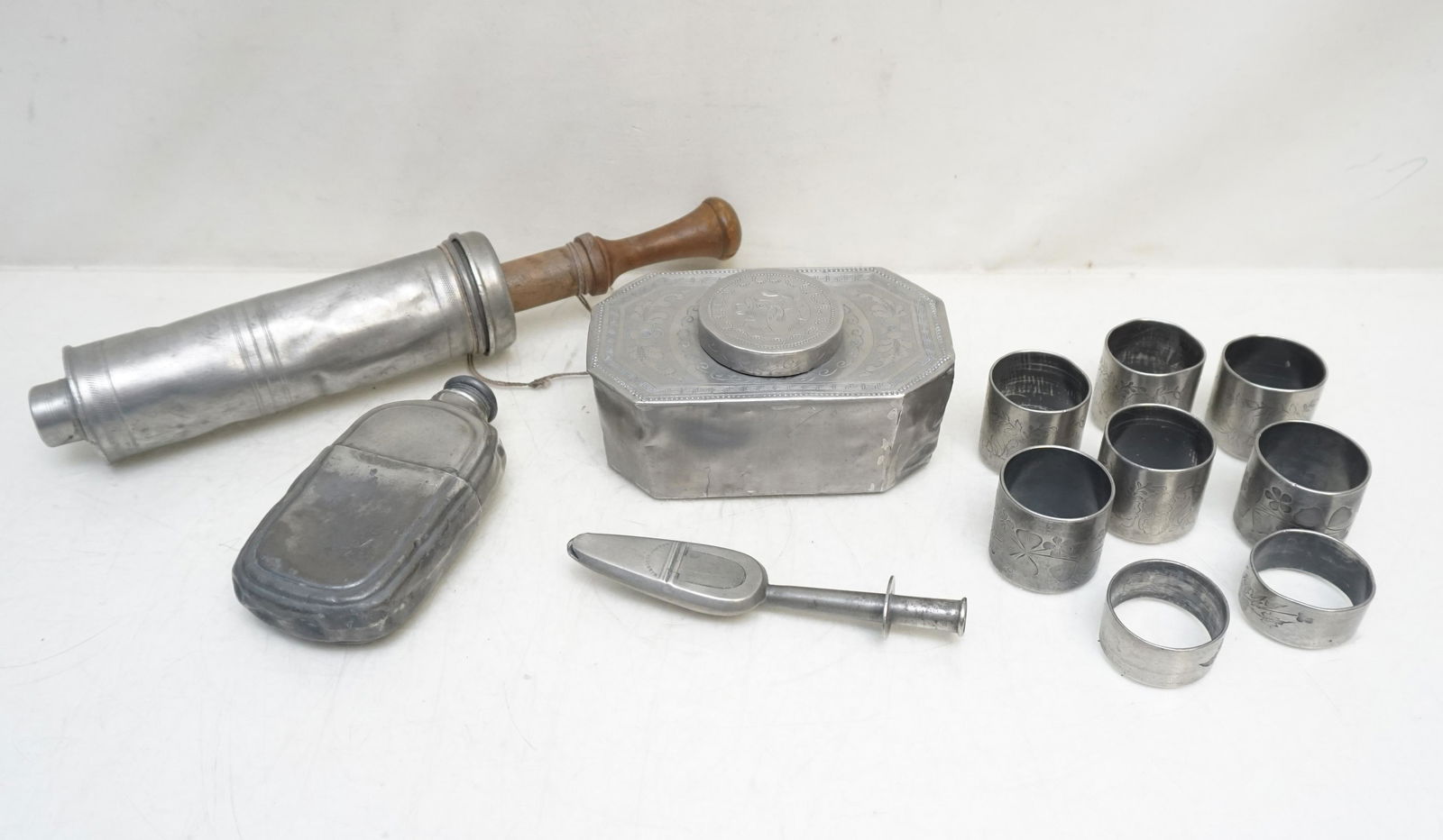 6 PC ANTIQUE 19TH C PEWTER: All are Antique Pewter. 1- Pewter Gibson Inventor Medicine Spoon 5 1/2. 2- Pewter Shaker Flask, unmarked 5". 3- Engraved Pewter Tea Caddy 5". unmarked. 4- Dutch Pewter Sausage / Pastry Maker 12". 5- 6