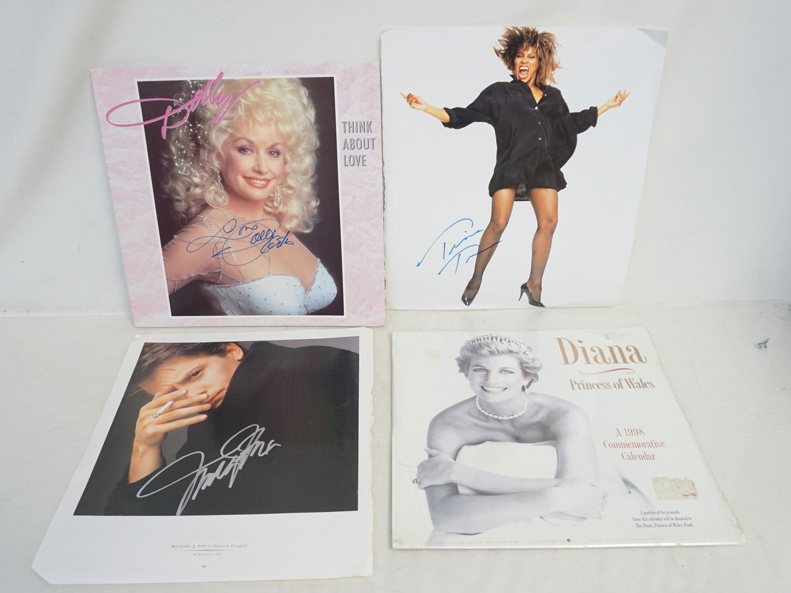 AUTOGRAPHS TINA TURNER - DOLLY PARTON - MICHAEL J FOX: 1- Autographed Dolly Parton LP Cover with COA- no record. 2- 1987 Autographed Michael J Fox. 3- Autographed Tina Turner. In addition there is a 1998 Commemorative Calender Diana Princess of Wales stil