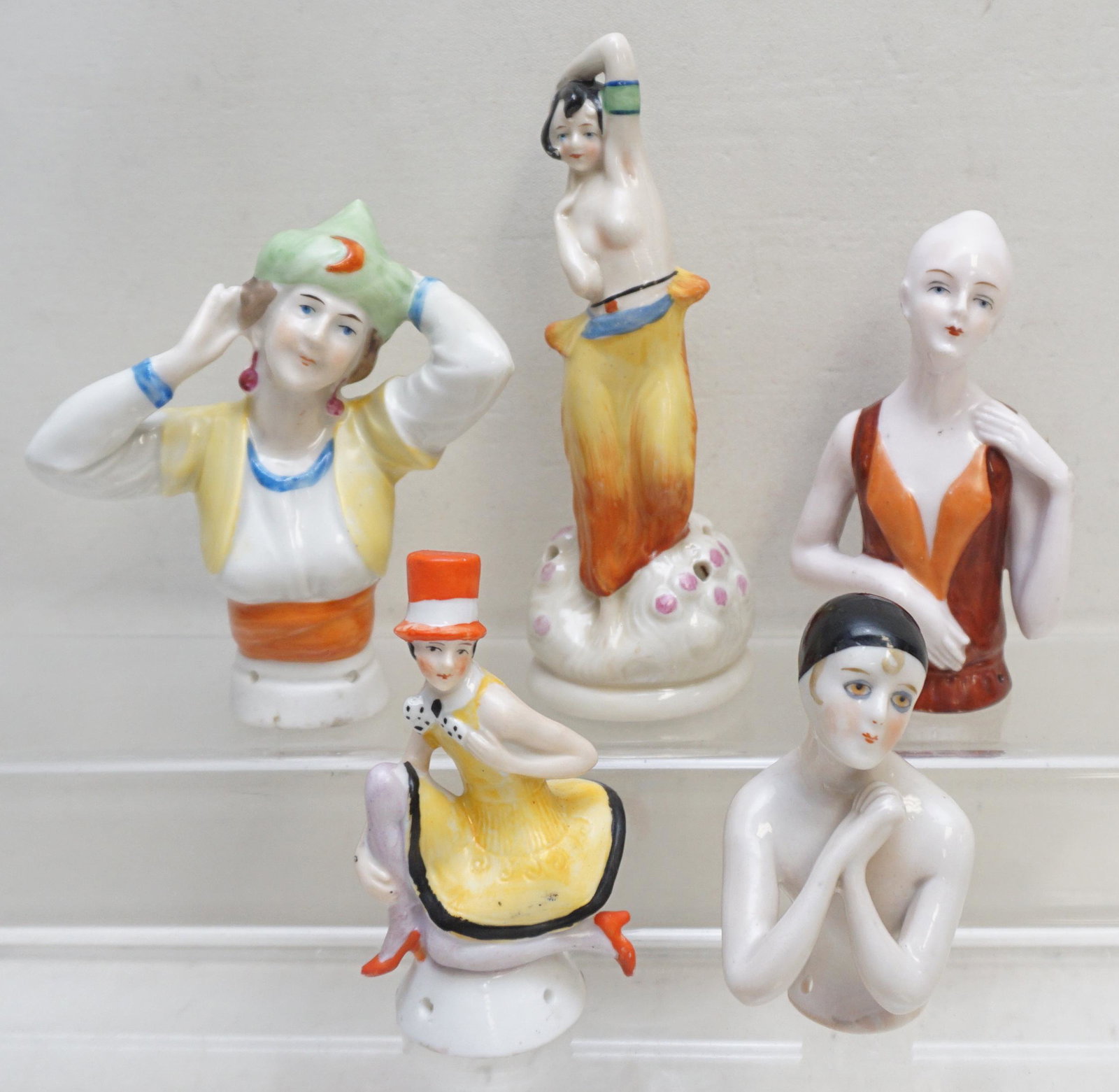 5 VINTAGE ART DECO NUDE + PORCELAIN PINCUSHION DOLLS: Five Vintage Art Deco Era 1920-1930s German Porcelain Pincushion Dolls, Includes a very rare full body semi nude Harem Dancer. 1- Egyptian Harem Girl with Green Hat 3 3/4". 2- Topless Harem Dancer 5".