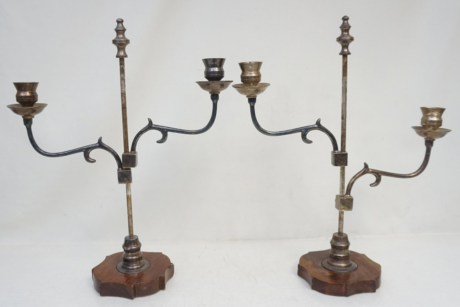 ARTS & CRAFTS ERA CANDELABRA: American Arts and Crafts style adjustable silver plate candelabra on shaped wood bases. Each 13"x13"x17". Weight 6 pds.
