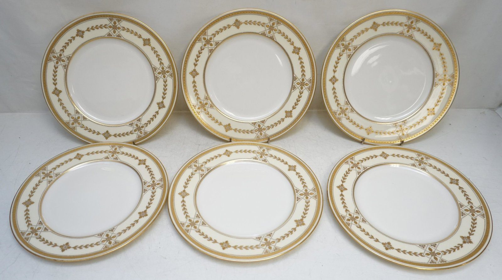 6 LENOX OVINGTON BROS NY GOLD DINNER PLATES: 6 Antique Lenox Fine Bone China Dinner Plates, made exclusively for Ovington Bros, New York, early 20th c. Cream with heavy hand enameled gilt. Each 10 1/2". Weight on all 5 pds 6 oz. Ovington Brother
