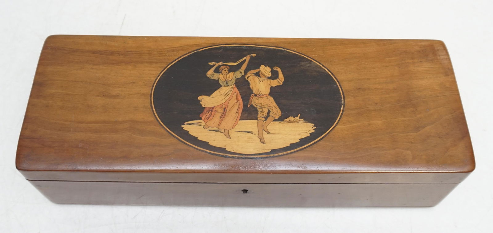 ITALIAN SORRENTO WARE GLOVE BOX: Antique Italian Sorrento Ware Inlaid Glove Box. The hinged lid inlaid with an oval panel depicting a dancing couple. Missing key. Measures 12"x4 1/2"x3". Weight 1 pd 7 oz. PROVENANCE: A Private Charle