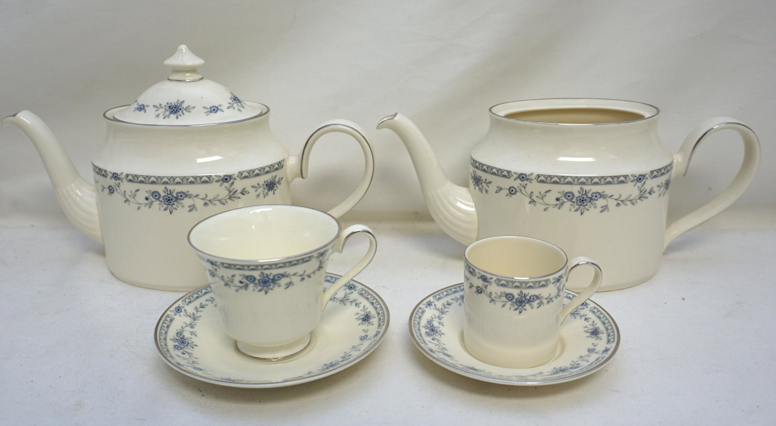 30 PC MINTON BELLEMEADE TEAPOT & CUPS: All are Minton Bellemeade, blue floral, platinum inner ring. 8 Bellemeade Footed Cup & Saucer Sets. 6 Bellemeade Flat Demitasse Cup & Saucer Sets 2 1/2" tall. 1 Bellmeade Teapot & Lid 7" to top of lid