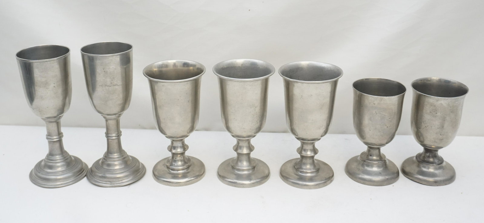 7 ANTIQUE AMERICAN PEWTER CHALICES: All are Antique. 1- Three Reed & Barton Taunton, Massachusetts pewter chalices 6 3/4". good, minor wear. 2- Pair of Short Reed & Barton Taunton, Massachusetts pewter chalices 5 3/4". .good, minor wear