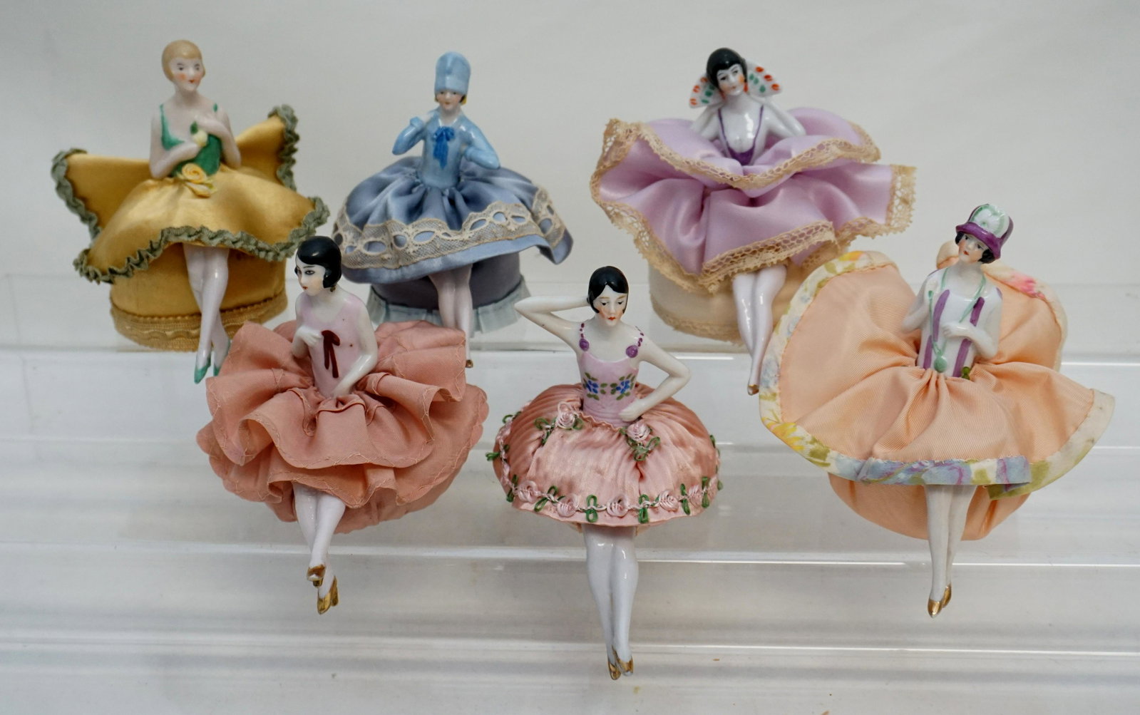 6 GERMAN PORCELAIN HALF DOLL PINCUSHIONS: Six (6) Art Deco Era Elegant 1920s-30s German Porcelain Pincushion Half Dolls with legs. Beautifully dressed. All in good condition, see all photographs.All measure 4" to 4 1/4". Weight on all 1 pd. P