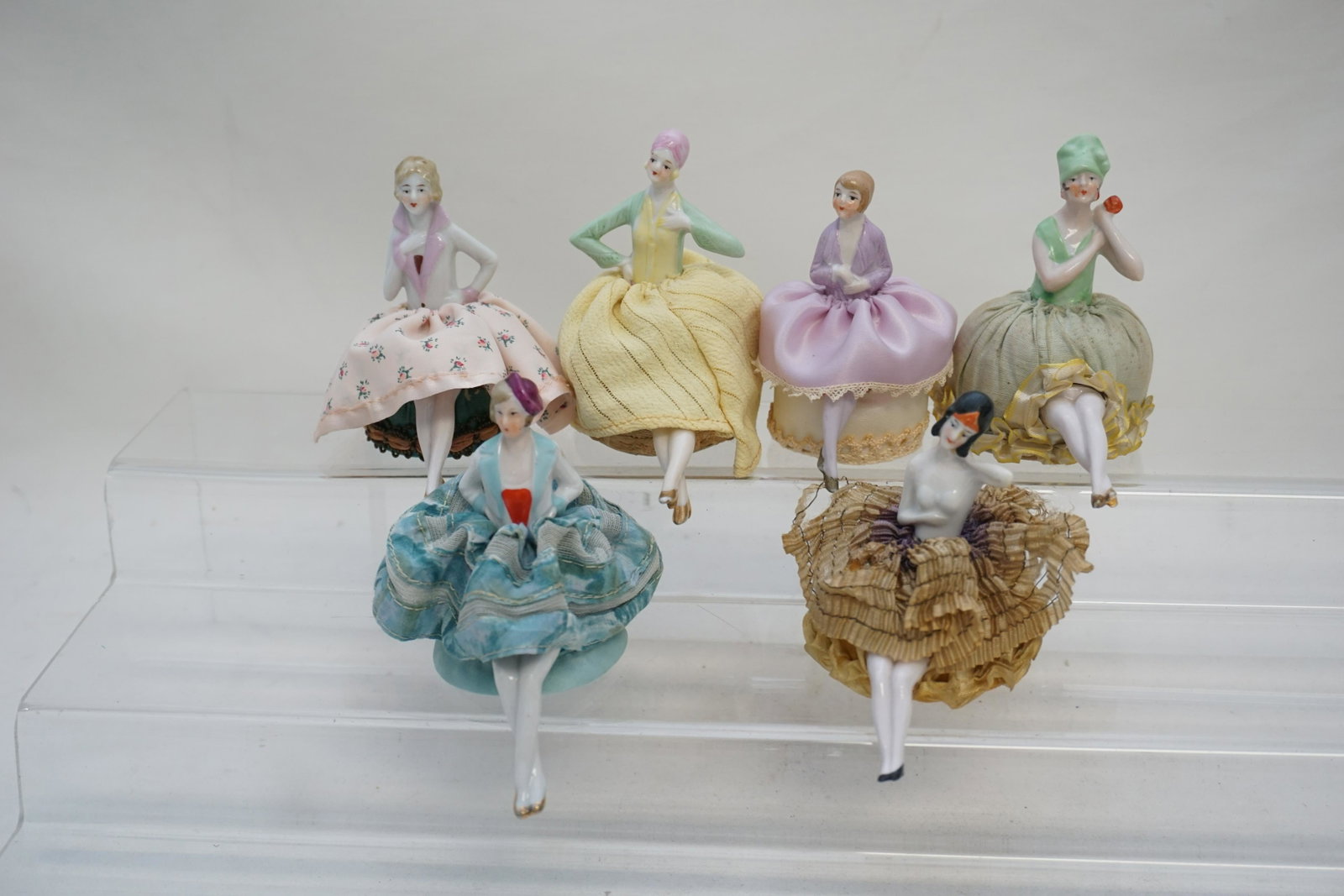 6 GERMAN PORCELAIN HALF DOLL PINCUSHIONS: Six (6) Art Deco Era Elegant 1920s-30s German Porcelain Pincushion Half Dolls with legs. Beautifully dressed. All in good condition, see all photographs.3" to 3 1/2". Weight on all 10 oz. PROVENANCE: 