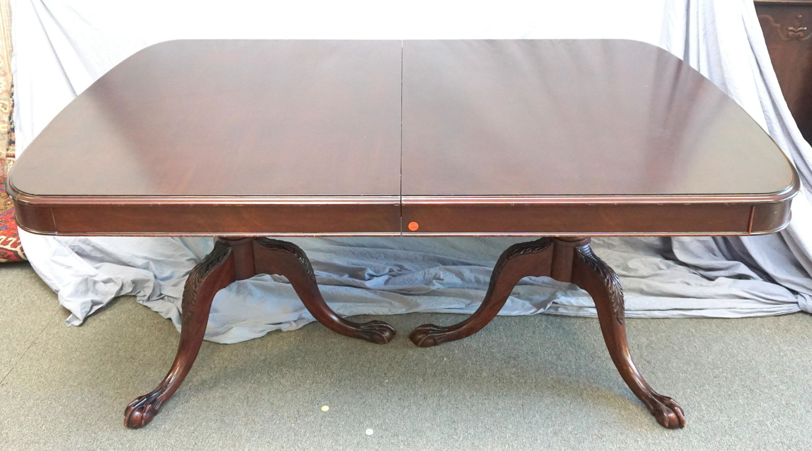 MAHOGANY CHIPPENDALE DINING TABLE: Late 19th, Early 20th c. Chippendale Style Carved Mahogany Ball & Claw Double Pedestal Dining Room Table. With 2 Leaves. Overall good condition with minor wear and scuffs. Measures 67 1/2"x44"x30" wit