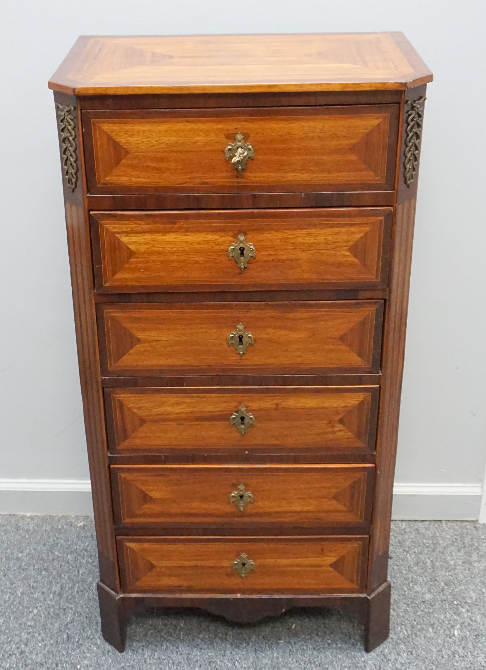 FRENCH LINGERIE CHEST: French Lingerie Chest, early 20th c. with book matched rosewood and tulipwood veneer with brass mounts to the upper stiles. 6 locking drawers with key. Measures 20"x12 1/2"x39". PROVENANCE: A Private 