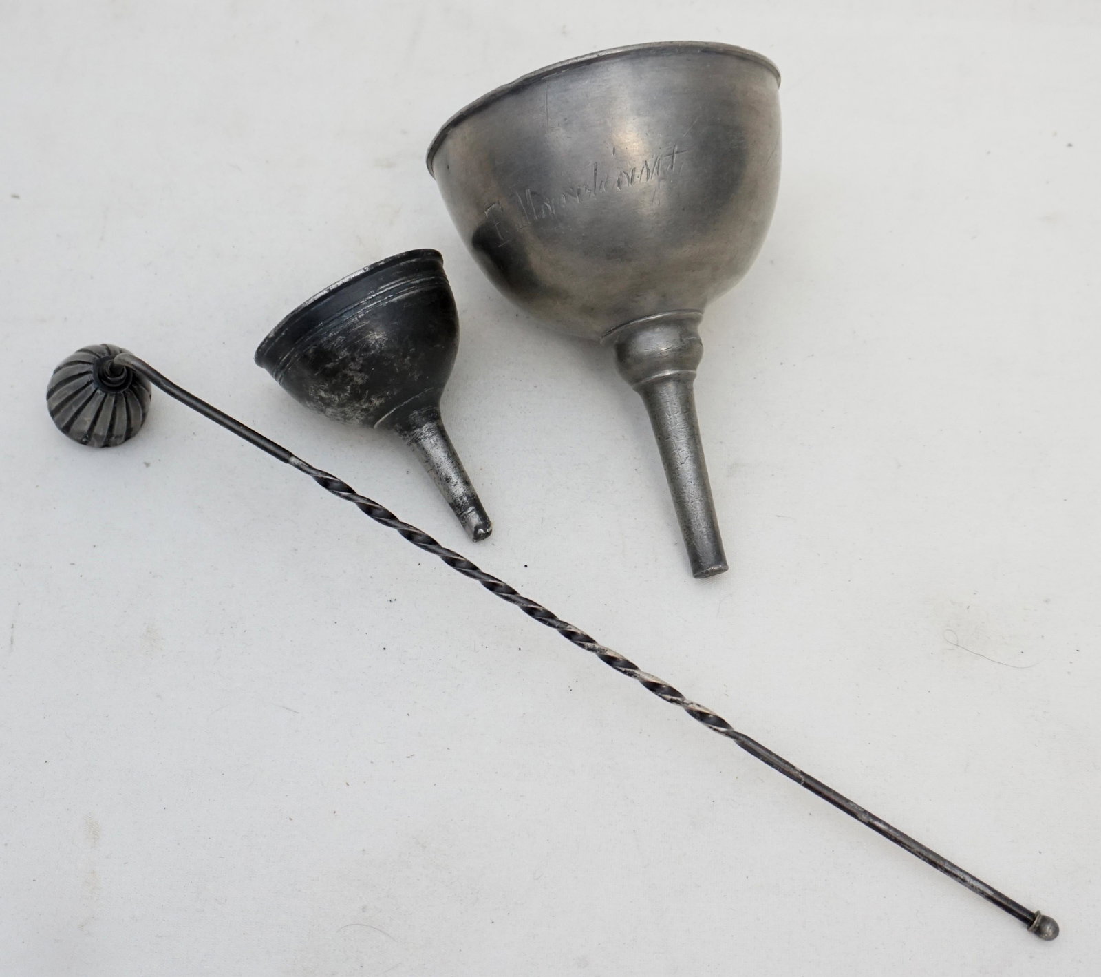 3 ANTIQUE PEWTER FUNNELS + SNUFFER: 1- Antique Pewter Wine Funnel with attached Ring. 4"x6". French. 2- Small Funnel 2 1/4"x3 1/4", no marks. 3- Pewter Candle Snuffer with twist handle 12 1/4", Weight on all 1 pd 2 oz. PROVENANCE: A Pri
