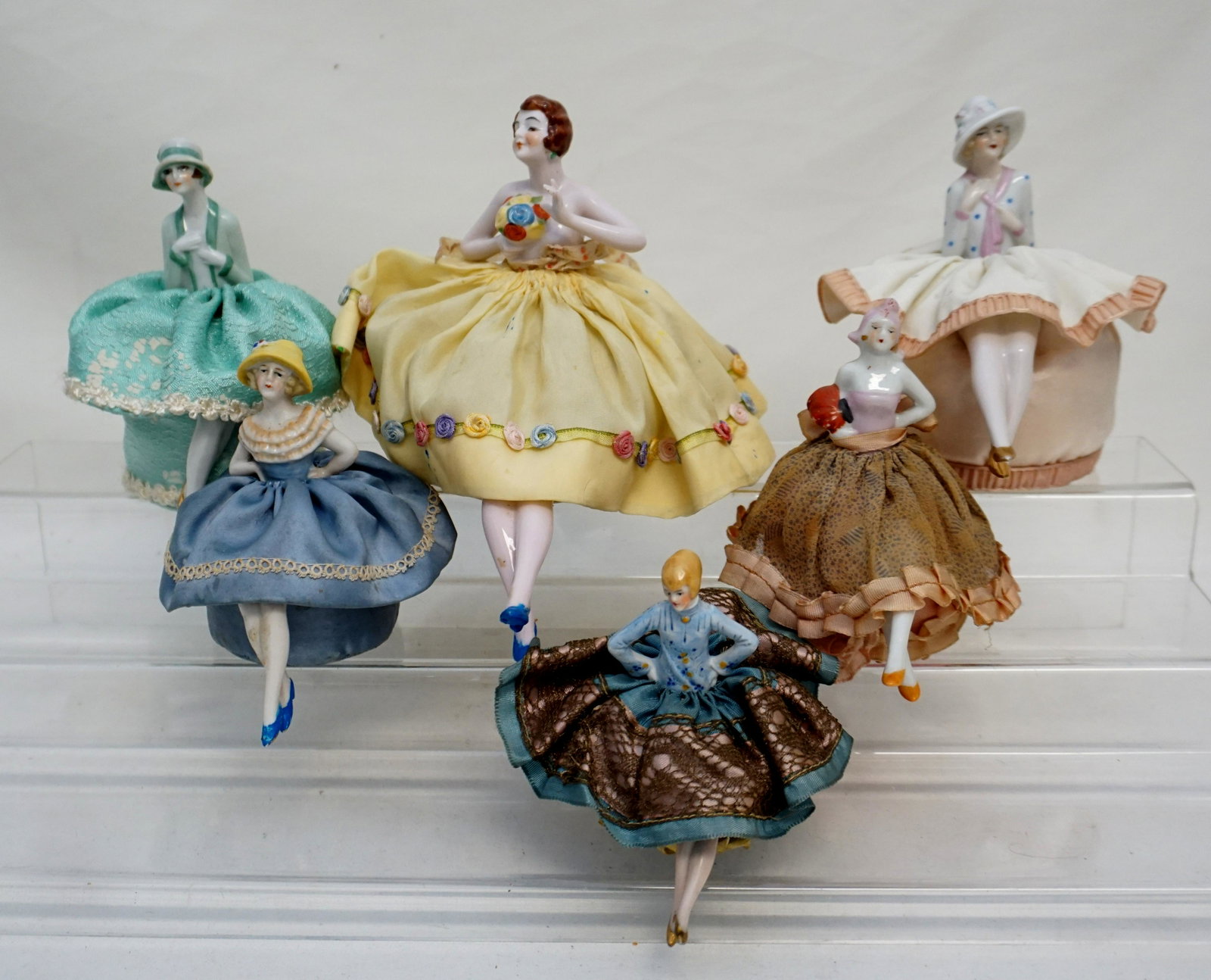 6 GERMAN PORCELAIN HALF DOLL PINCUSHIONS: Six (6) Art Deco Era Elegant 1920s-30s German Porcelain Pincushion Half Dolls with legs. Beautifully dressed. All in good condition, minor wear to clothing, see all photographs.All measure 3 3/4" to 5