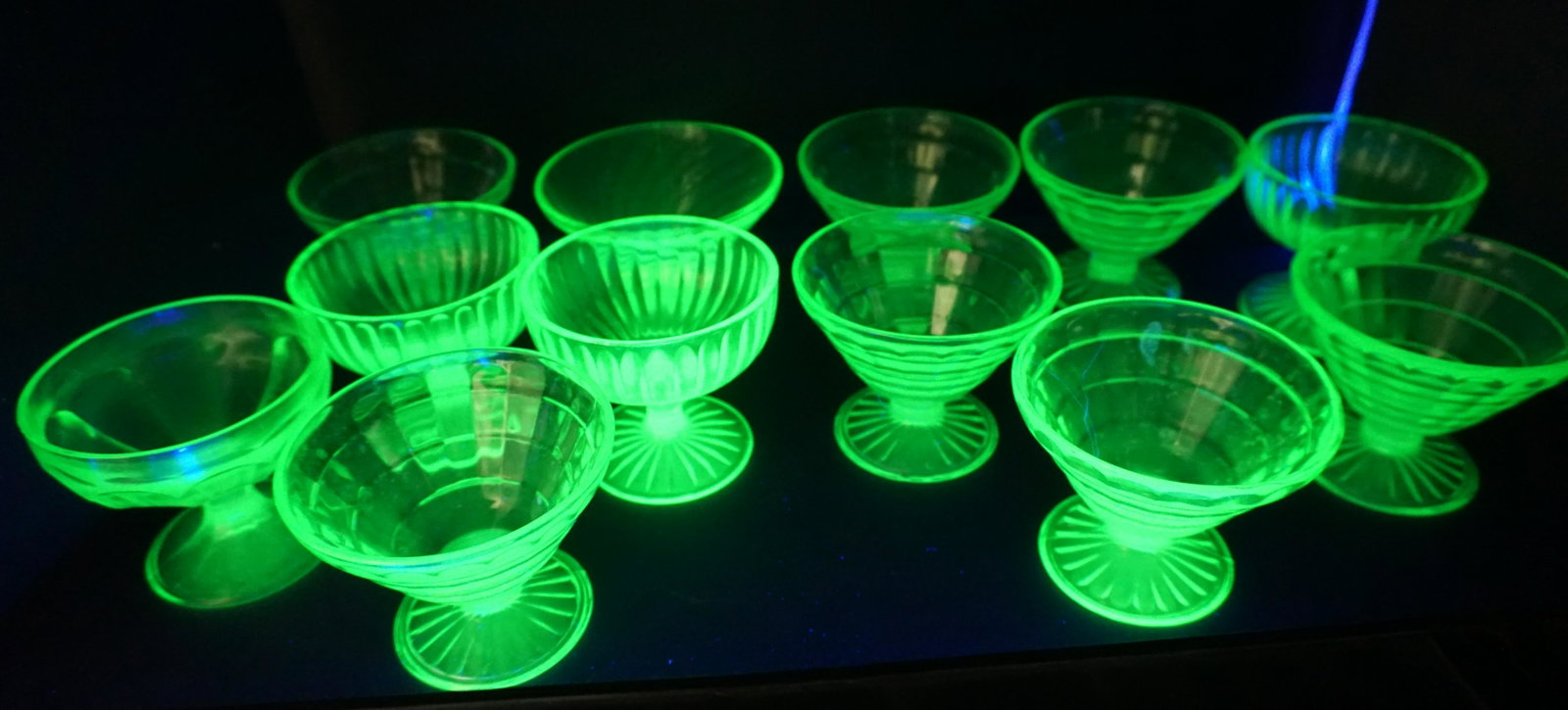 17 VINTAGE VASELINE GLASS SHERBETS: 17 Vintage Vaseline Glass Sherbets. Includes 10 Hocking Block Optic. 3 Block Optic Swirl, 3 Ribbed Optic and 1 Wide Ribbed. All approximately 3" high. Weight on all 6 pds 13 oz. PROVENANCE: Edwin Moor
