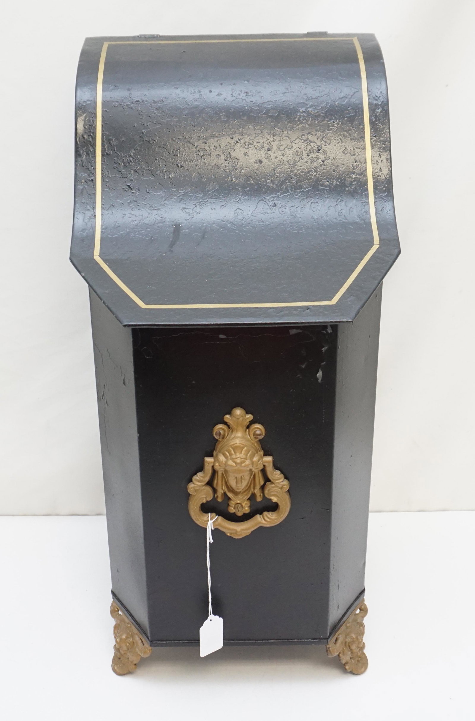 BLACK COAL BIN WITH GILT FEET: Black Painted Coal Bin with gilt feet, gilt accented top and Victorian Maiden Head door knocker to front.. Measures 12"x12"x24". Weight approximately 20 pds. PROVENANCE: A Private Charleston SC Estate