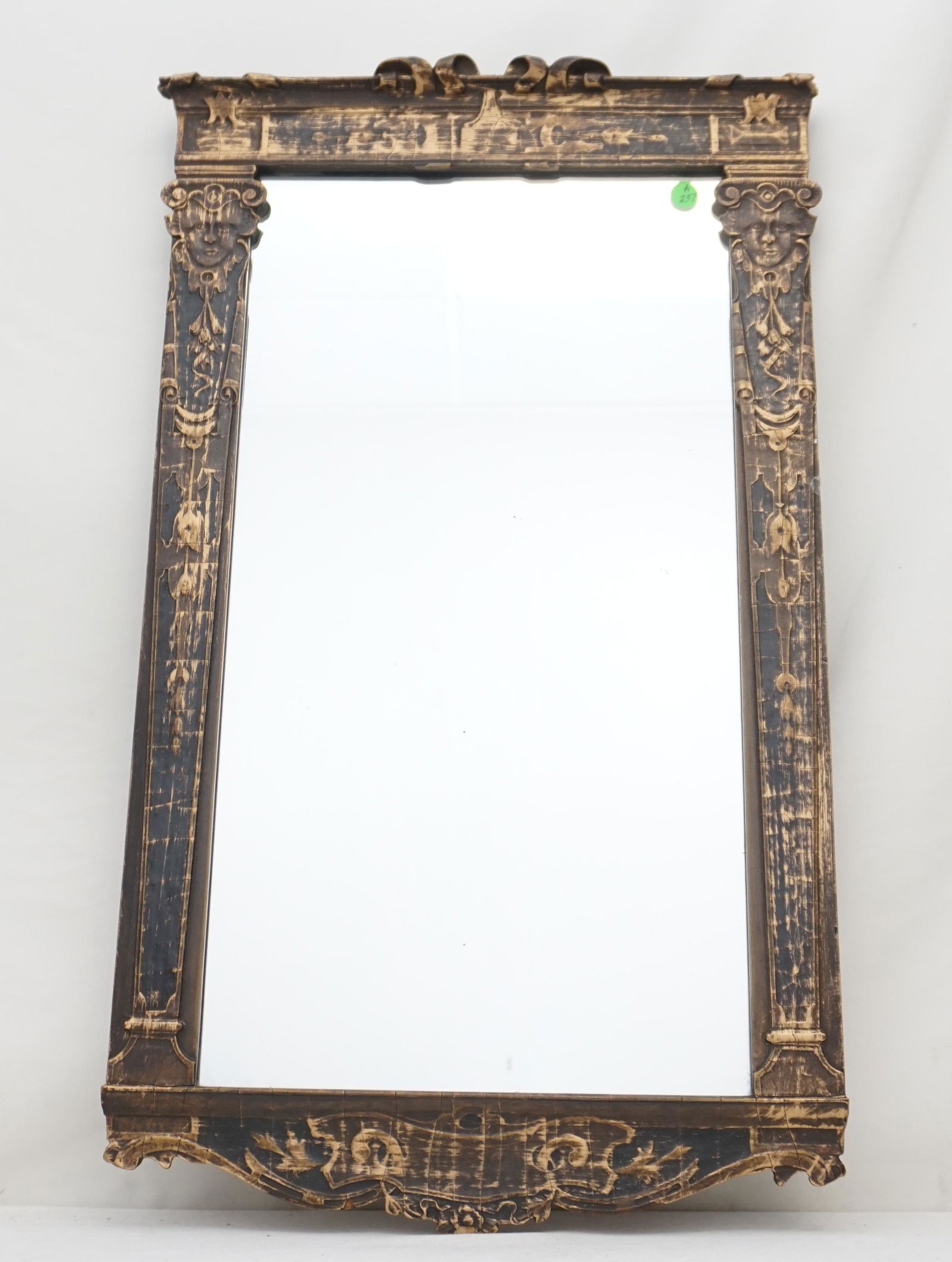 ART NOUVEAU ANTIQUE CARVED MIRROR: Antique Art Nouveau Carved Wood and Gesso Mirror. Carved faces, lilies and scrolled ribbons. Measures 17"x29 1/2"x1 1/2". Weight 10 pds. PROVENANCE: A Private Charleston SC Estate. NO IN HOUSE SHIPPIN