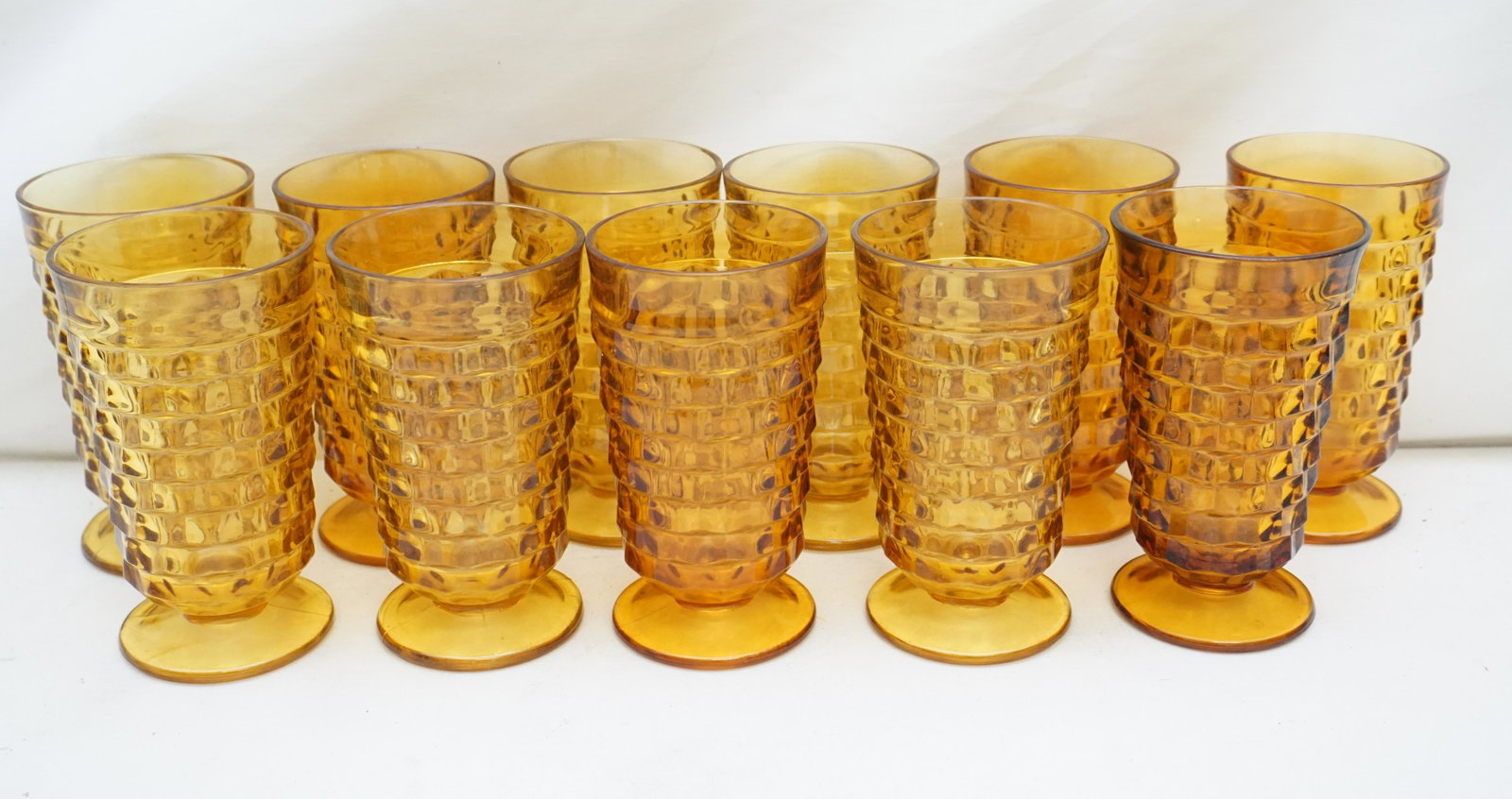 11 WHITEHALL AMBER ICED TEA: Eleven Vintage Whitehall Amber Iced Tea Glasses by Colony. Each 3 1/2" wide and 6" tall. Weight on all 12 pds PROVENANCE: Edwin Moore Brogdon, PhD, collection. Dr. Brogdon was the owner of Brogdon Man