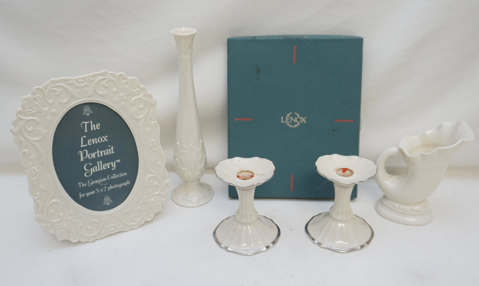 5 pc LENOX GIFTWARE: 5 Piece Vintage Lenox Giftware. 1- Picture Frame in Box for 5"x7" photo. 2- Pair (2) Platinum trimmed Candlesticks 4 1/2". 3- Cornucopia Vase 6". 4- Bud Vase 10 3/4". Weight on all 3 pds 15 oz.. PROVE
