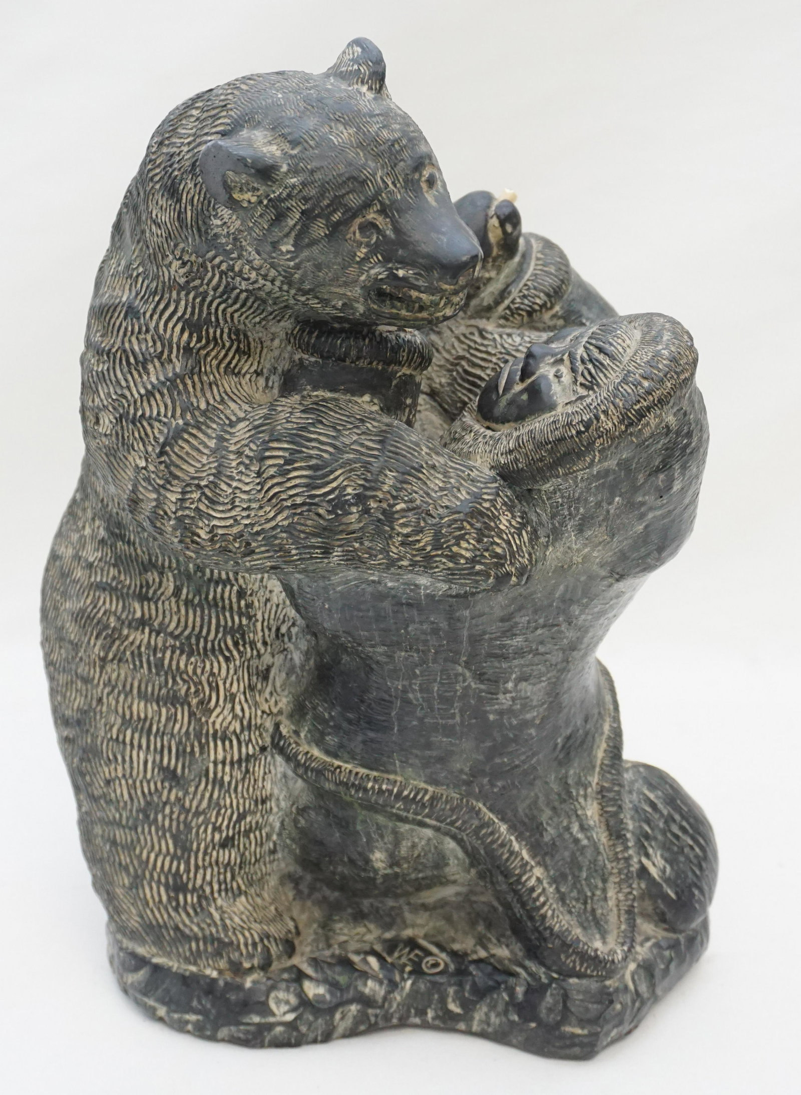WOLF ORIGINAL ESKIMO & POLAR BEAR: Wolf Original Sculpture Eskimo & Polar Bear. Cast material with soapstone style applied finish. Label to base. Good condition. 12". Weight 14 pds. NO IN HOUSE SHIPPING ON THIS LOT. PROVENANCE: A Priva