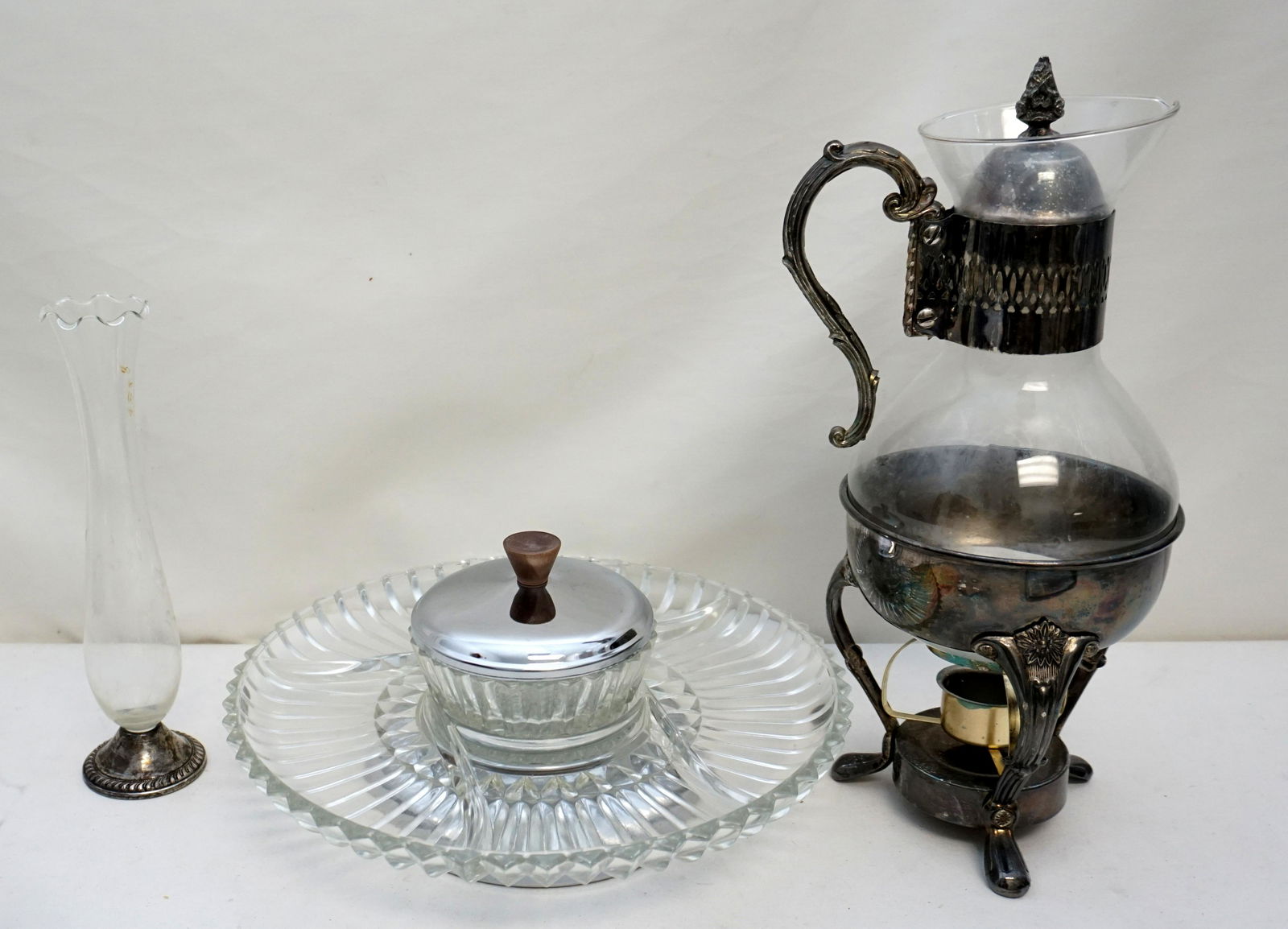 3 PC MID CENTURY SILVER PLATE: All are Vintage 1950s Mid Century. 1- Kromex Lazy Susan in the original Box. 2- Sterling Footed Etched Bud Vase 9 1/2". 3- Glass Coffee Pot with Warmer. 13" on stand. Weight on all 9 pds.