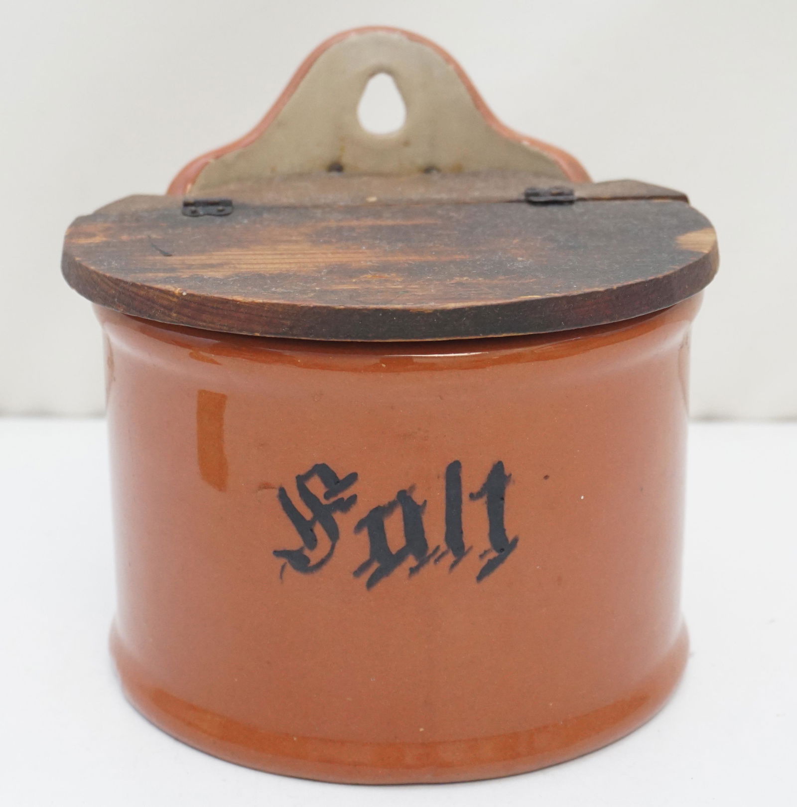 GUERNSEY STONEWARE SALT CROCK: 1920s Guernsey Cooking Ware Salt Crock. In very good vintage condition. A rusty brown stoneware crock with the word Salt on the front in a black font. You can hang it on the wall or leave it sitting o