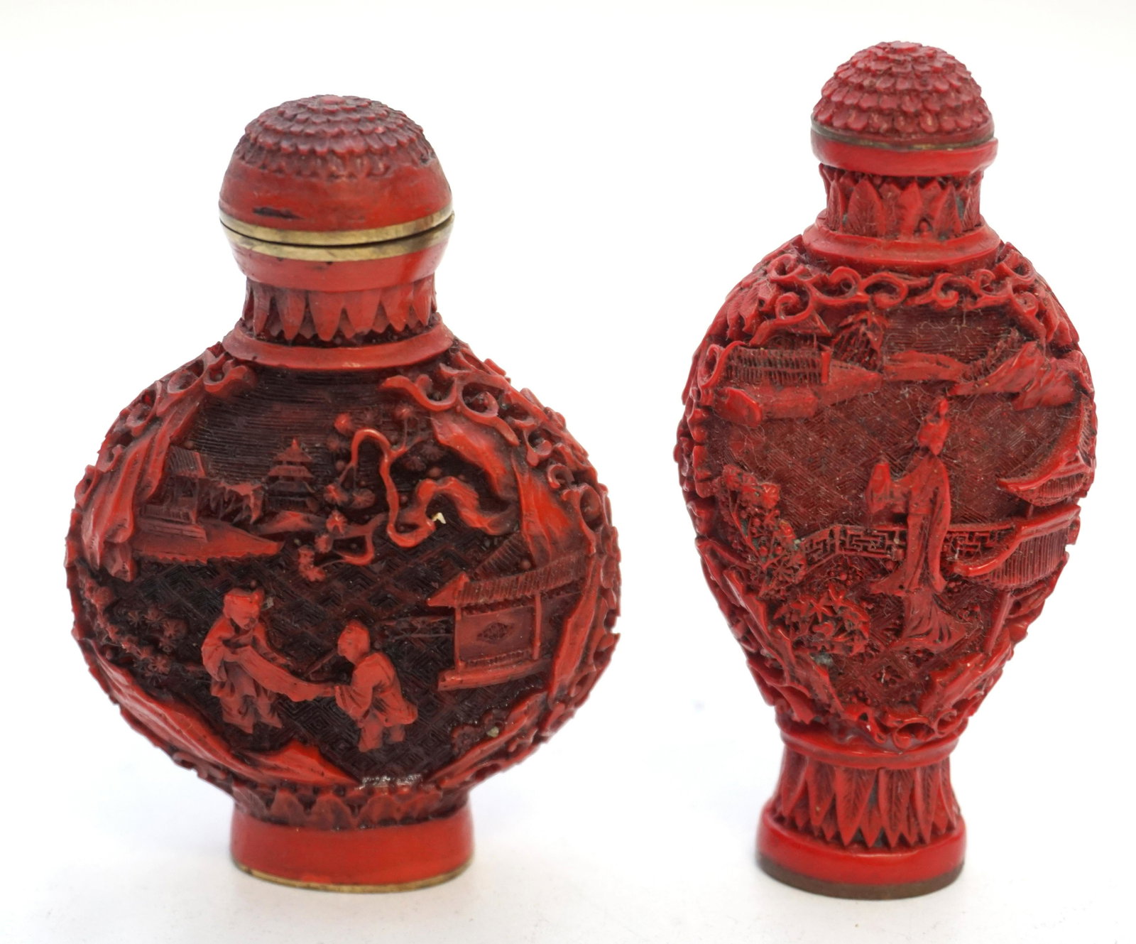 PAIR QIANLONG CINNABAR SNUFF BOTTLES: Pair of Chinese Cinnabar on Bronze Snuff Bottles. Signed. Both with Carved Garden and People scenes 2 3/4. One stopper with chipped tim and stopper glued in . Weight 3 oz. PROVENANCE: A Private Charle