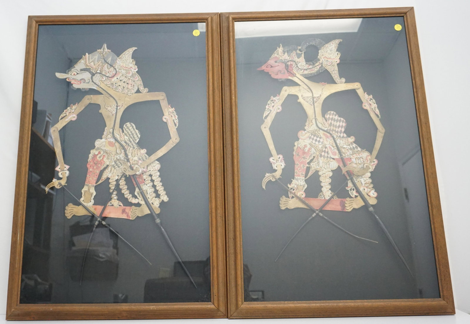 PAIR FRAMED WAYANG KULIT PUPPETS: Pair of Antique Leather Hide Wayang Kulit Puppets from Java. In matching shadow box frames. A form of puppet theatre art found in Indonesia and other parts of Southeast Asia, wherein a dramatic story 