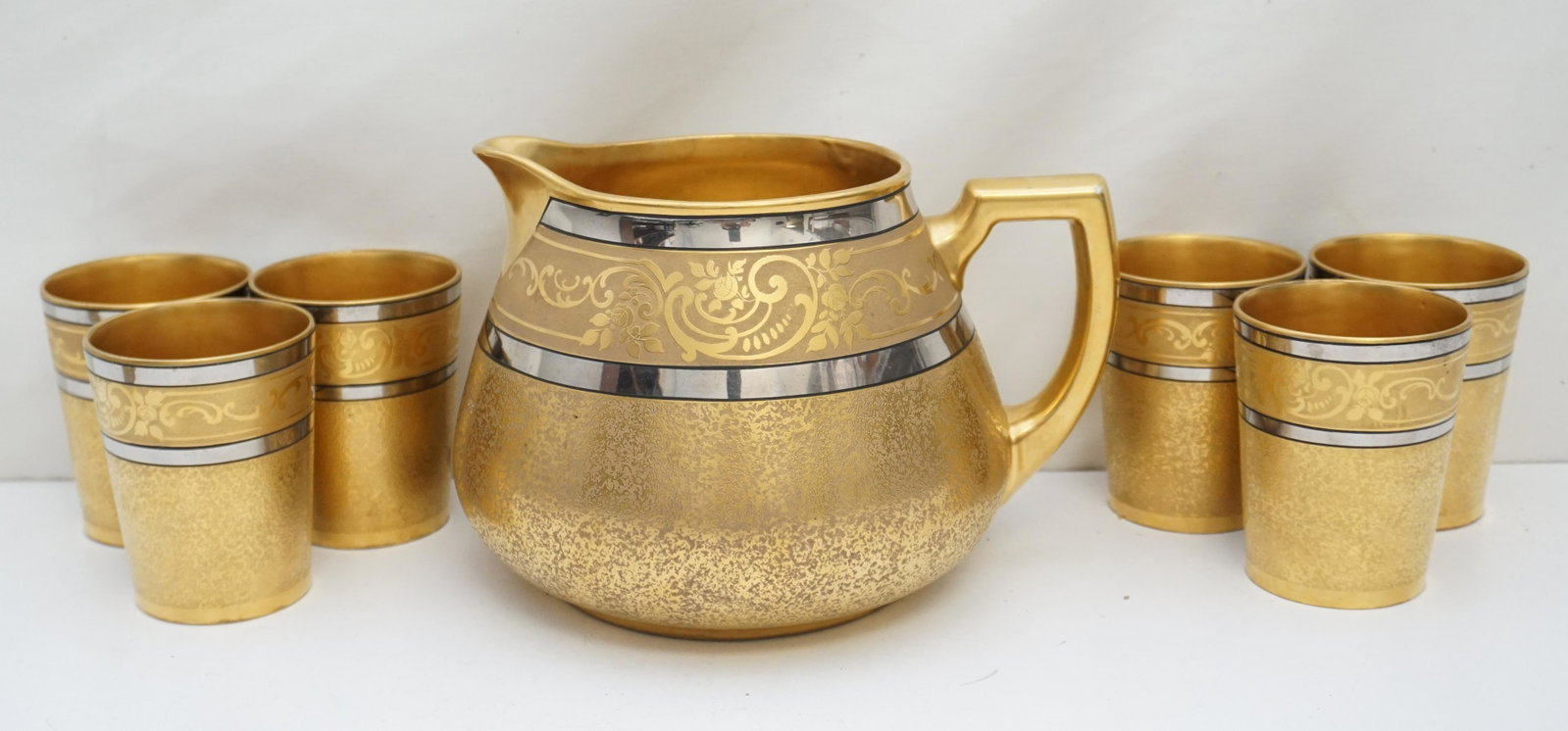 OSBORNE 22K CIDER / LEMONADE SET: Exceptional Antique c. 1910-20 hand painted 22kt gold relief and silver Porcelain Cider / Lemonade Set from Osborne Art Studio.The 6 cups are Tressemann and Vogt Limoges and the Cider Jug is Porzellan