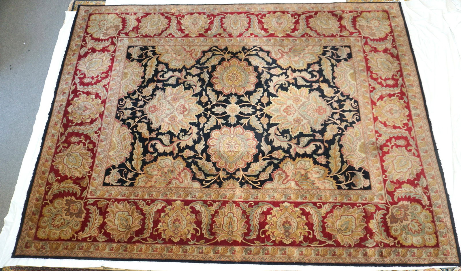 FINE PESHAWAR HAND KNOTTED LARGE RUG: Fine Hand Knotted Pakistan Peshawar Large Area Rug measures 12'3"x9'2". Blacks, Reds, Golds, Ivory. Purchased at Newton Oriental Rugs in Framingham, Mass. Minor wear to edges. PROVENANCE: A Private Ch