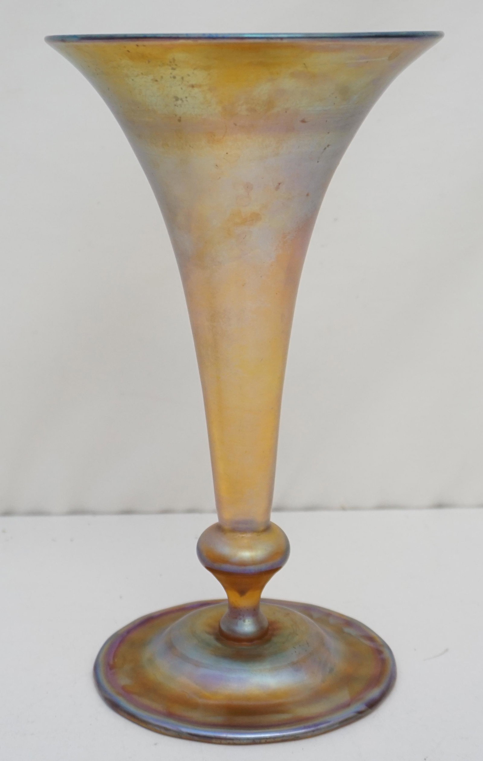 LOUIS COMFORT TIFFANY FAVRILE TRUMPET VASE: Tiffany Favrile Trumpet Vase. Raised on a ball and dome base. Underside bears etched signature reading "L.C.Tiffany Favrile 1533. Measures 6"x6"x10 1/4". Weight 1 pd 8 oz. Crystal/Glass. PROVENANCE: A