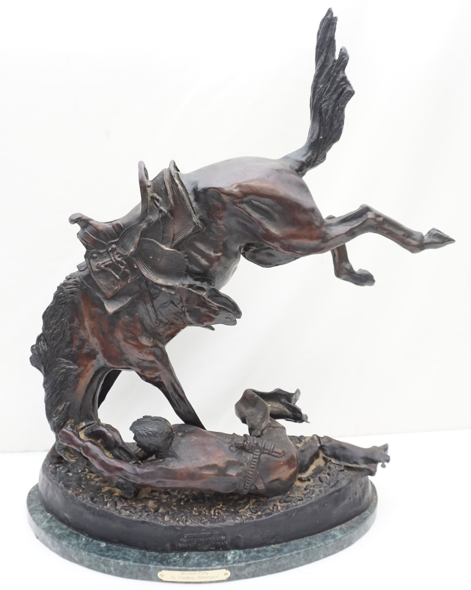 FREDERIC REMINGTON WICKED PONY BRONZE: 20th c. after Frederic Remington Bronze "Wicked Pony". Inscription on Bronze reads "Dedicated to Henry Dearborn secretary of War 1904". On Green Marble base with brass plaque.. Measures 18"x9"x23". We