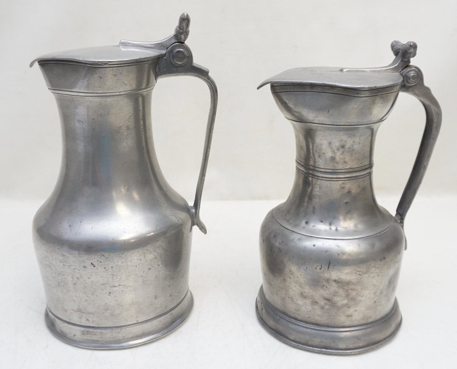 2 ANTIQUE 18th / 19th c PEWTER FLAGONS: 1- Antique 18th c. French Flagon with twin acorn thumbpiece 8 1/2" . 2- Early 19th c. Swiss Flagon twin acorn thumbpiece, this falgon is from the Violette De Mazia Collection and was purchased at Chri