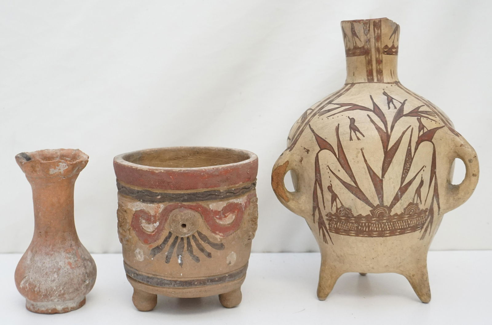 3 pc INDIGENOUS POTTERY: 3 Pieces Indigenous Peoples Pottery. All are old. 1-Tri Footed Pot with Crows/ Birds spreading Seed 11" tall, chips to neck, neck glued.chip to handle. 2- Open Pot Mayan 5 3/4". 3- Vase 5 3/4". Weight