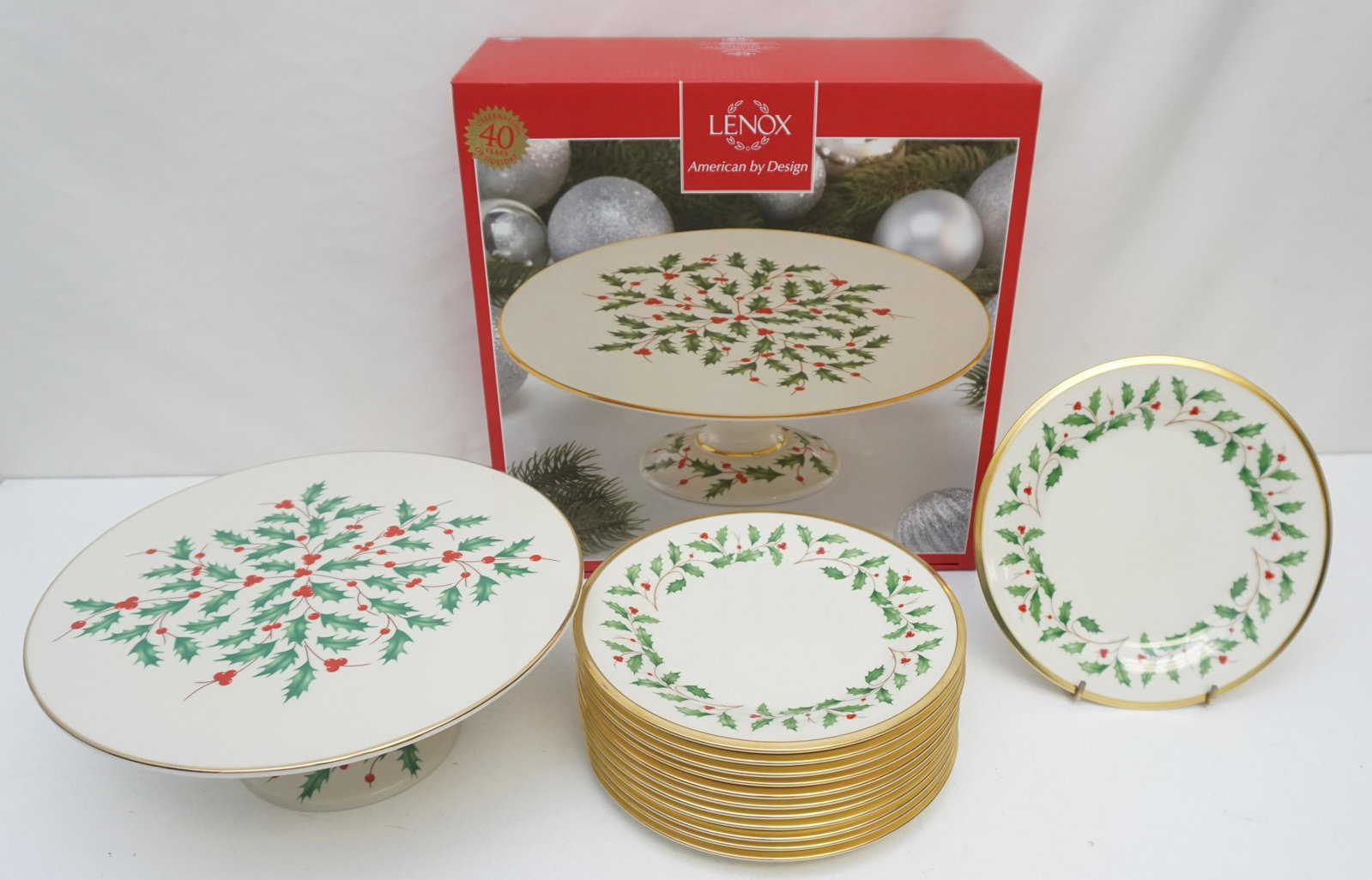 LENOX HOLIDAY CAKE PLATE + 12 DESSERT PLATES: Lenox Holiday Footed Cake Plate 11:, still in box and Twelve (12) Holiday (Dimension) Fine Bone China Dessert Plates from Lenox. Like new, unused, many with the price tags still on. Dimension Shape, H