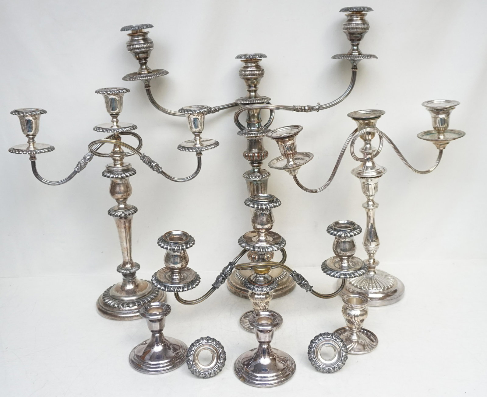 7 pc SILVERPLATE CANDELABRA + CANDLESTICKS: 3 Vintage / Antique Various Silver Plated Candelabra and 2 Pairs of Candlesticks. Tallest is Silver on Copper 20". Weight on all 21 pds. PROVENANCE: Edwin Moore Brogdon, PhD, collection. NO IN HOUSE S