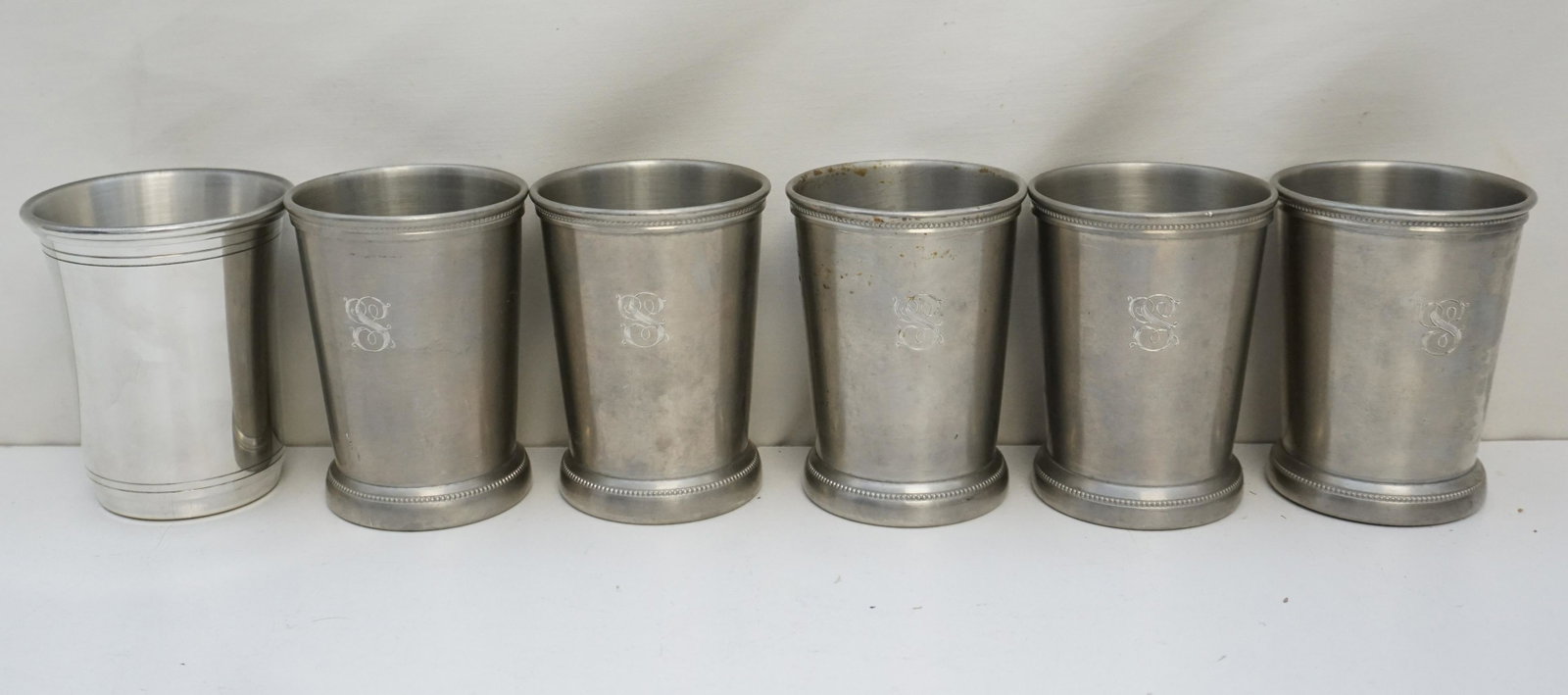 6 PEWTER MINT JULEP CUPS: 6 Vintage Pewter Mint Julep Cups. 5 Matching by International with Monograms and 1 Carolina Pewter Cup by Salsbury. All 4 1/4". Weight on =all PROVENANCE: Edwin Moore Brogdon, PhD, collection. Dr. Bro