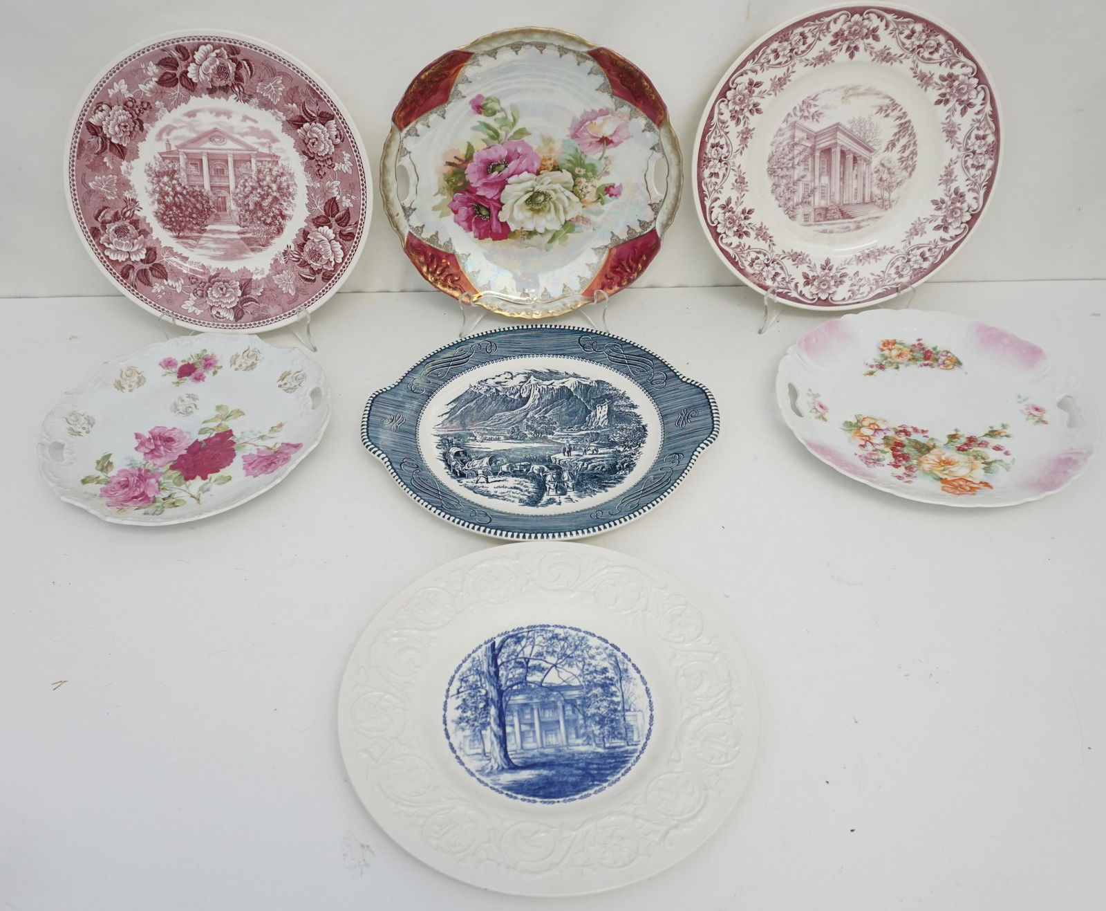 7 ANTIQUE / VINTAGE COLLECTOR PLATES: 3 Wedgwood Transfer Plates Hermitage Mansion, Rosalie, old Main, all 10 1/2". 1 Currier & Ives Rocky Mountain Cake Plate 11 1/2" (handles). 3 Unmarked German Porcelain Floral Cake Plates 9 1/2" to 10