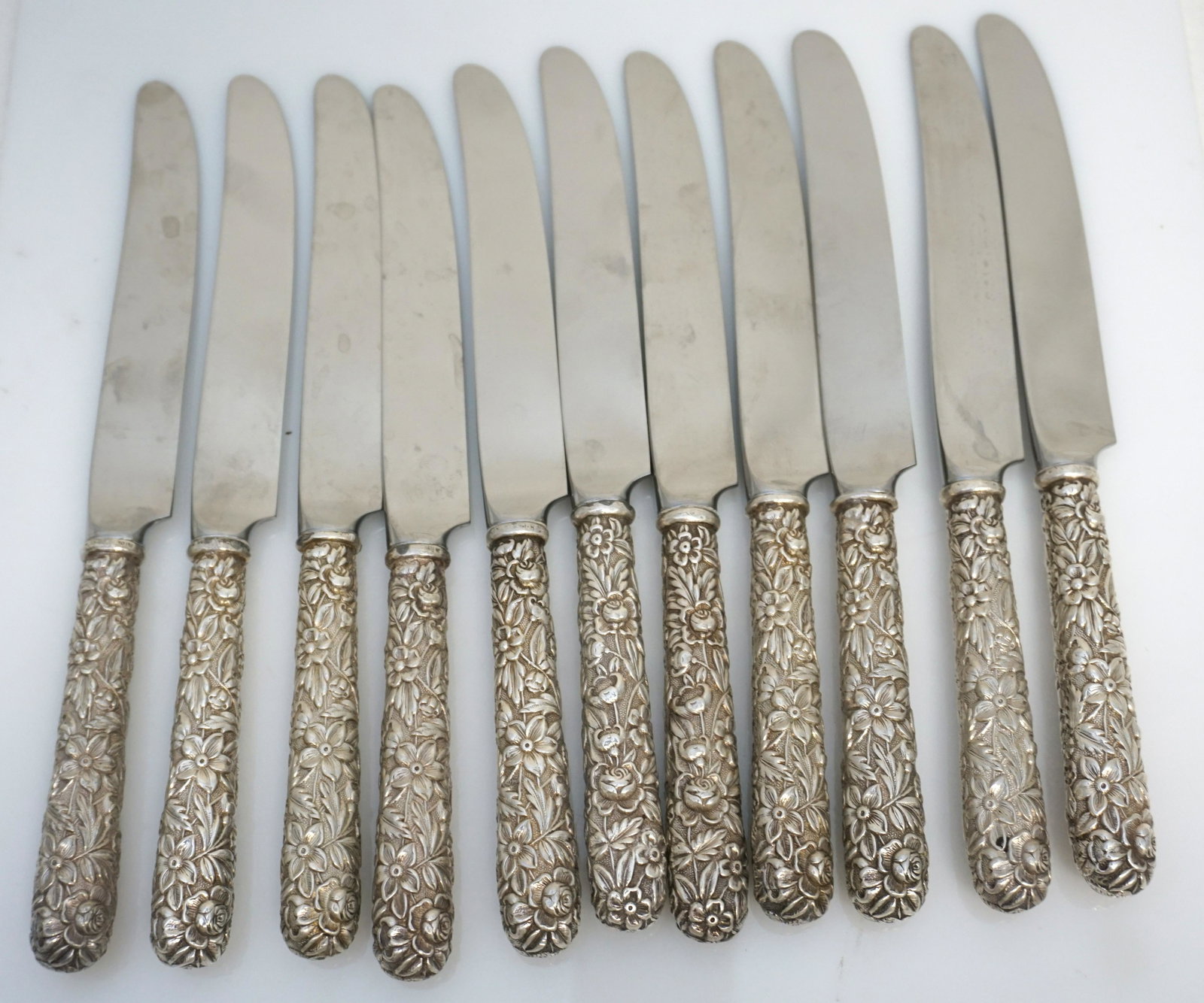 11 STERLING REPOUSSE KIRK STIEFF KNIVES: Eleven (11) Sterling Silver Handle Kirk Stieff Repousse Dinner Knives. Each 9". Weight on all 1 pd 13 oz. PROVENANCE: A Private Charleston SC Estate.The iconic Repousse silverware pattern by Kirk Stie