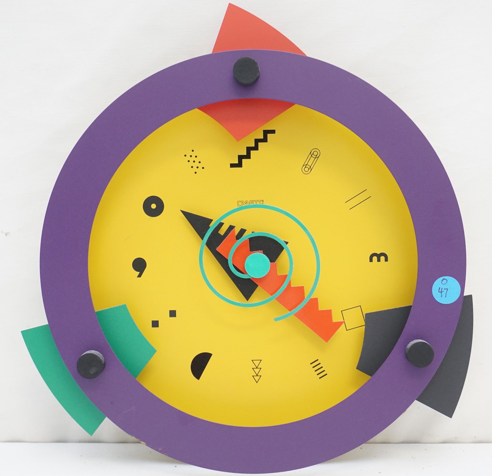 CANETTI 1980'S VINTAGE WALL CLOCK SCULPTURE: A vintage 1980s Canetti wall clock. The brightly colored clock is made of painted metal, featuring bold geometric shapes and patterns. It is marked â€œCanetti” to the dial, and the back is m
