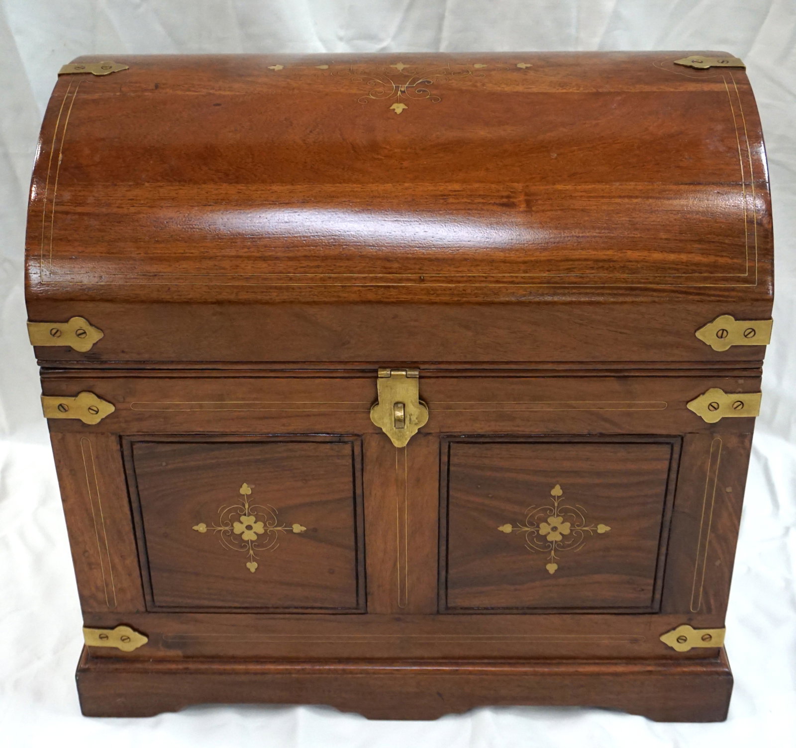 ROSEWOOD & BRASS INLAID CHEST: 20th c. Anglo Indian inlaid Brass Sheesham Rosewood Captains Style Chest, made in Pakistan. Having a domed lid with brass straps, inlaid with brass scrolling design, having two panels to front, interi
