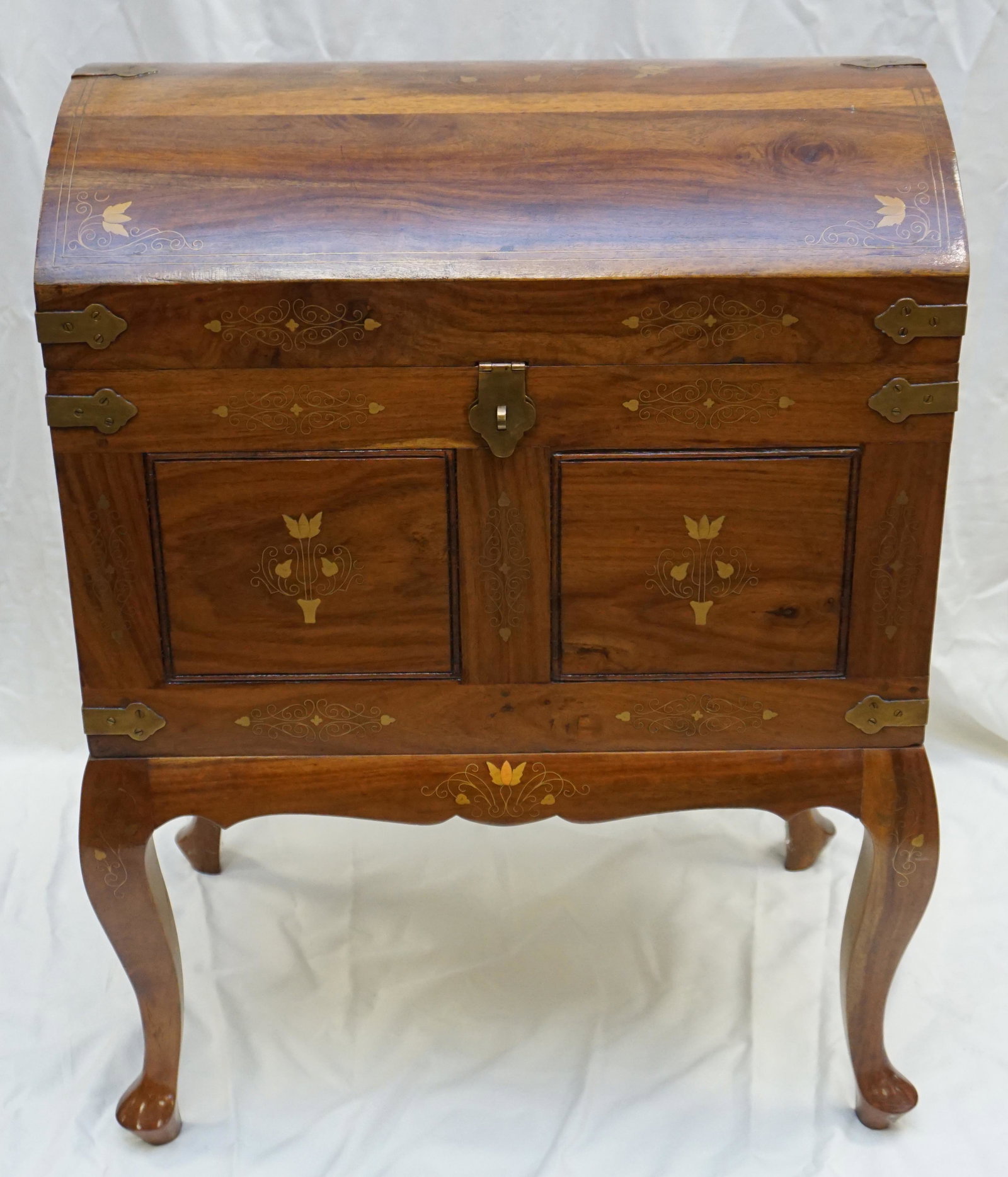 ROSEWOOD & BRASS INLAID CHEST: 20th c. Anglo Indian inlaid Brass Sheesham Rosewood Captains Style Chest on stand, made in Pakistan. Having a domed lid with brass straps, inlaid with brass scrolling design, having two panels to fron