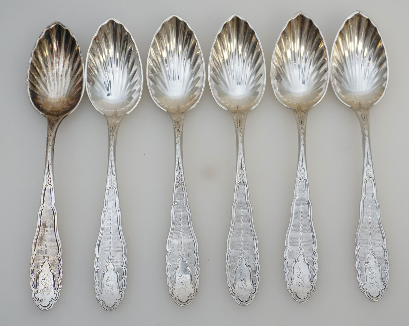 6 AMERICAN COIN SILVER ICE CREAM SPOONS: Six (6) Antique American 19th c. Ornate Coin Silver Ice Cream Spoons. With shell bowls and scalloped bright cut stylized handles. Monogrammed. Each 5 3/4". Weight on all approximately 110 grams. PROVE