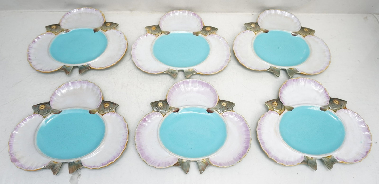 6 RARE MINTON MAJOLICA SEAFOOD PLATES: Six (6) Rare Antique c. 1875 English Minton Majolica Seafood Plates. In pink, white and turquoise centers. REF: shape no. 1497, Snyder pg. 15. All have minor nicks or flea bites. Still display well. S
