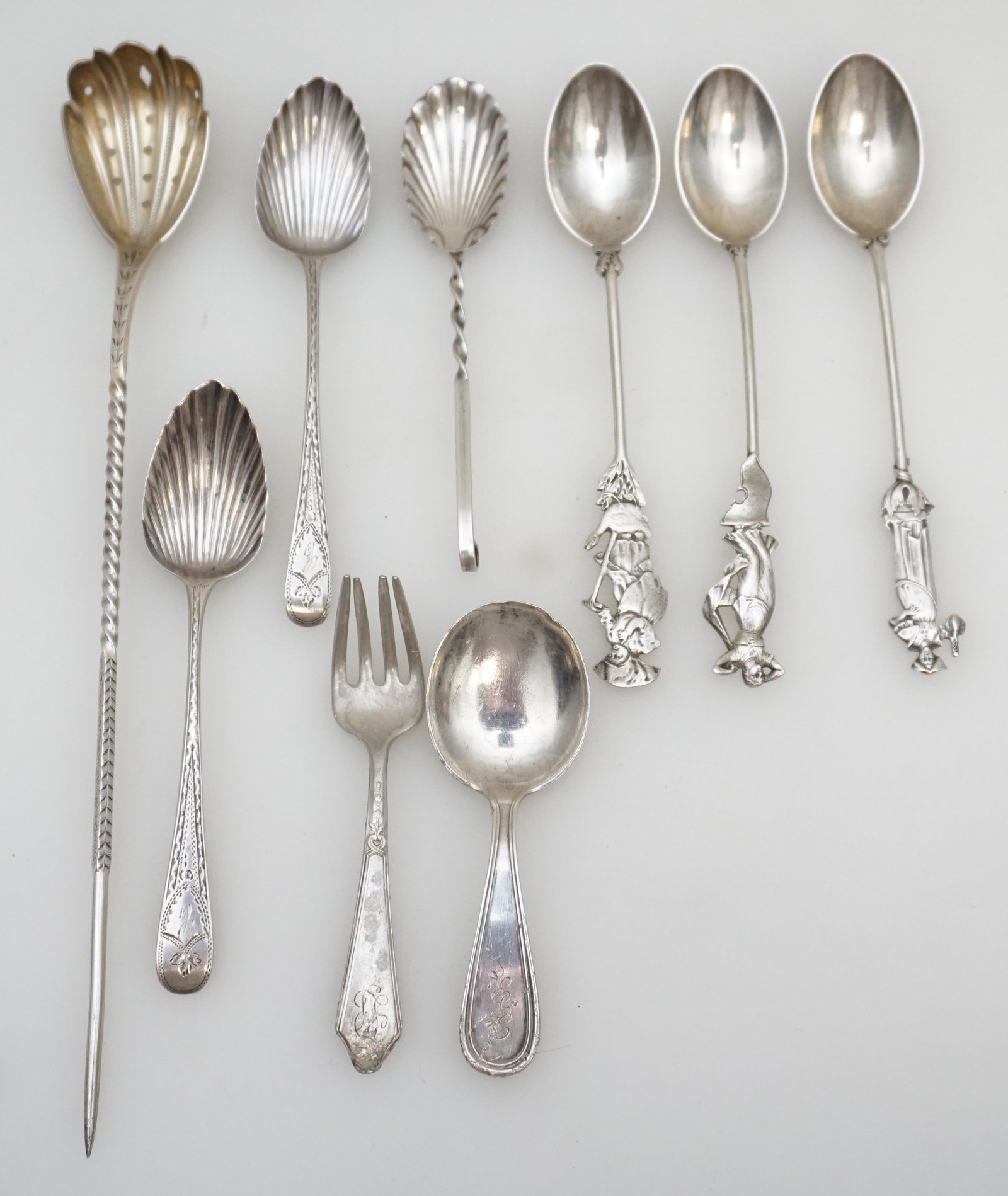 9 PC STERLING SILVER SPOONS+: All are Sterling Silver. 1- English Sterling Olive Spear / Spoon. Twist Handle, Pierced Bowl 9 1/4". 2- Pair English Sterling Silver Georgian Shell Bowl Engraved Spoons, monogrammed 5". 3- Three Gorha
