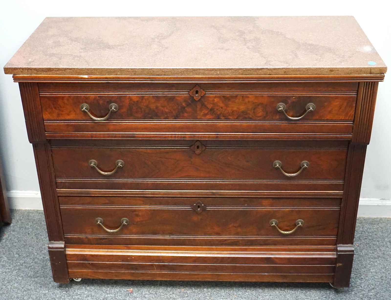 VICTORIAN EASTLAKE CHEST W GRANITE: Victorian Eastlake walnut chest, having a red granite rectangular top, above the case with three drawers, each having burl reserves. Measures 39"x17"x31". NO IN HOUSE SHIPPING. PROVENANCE: A Private C
