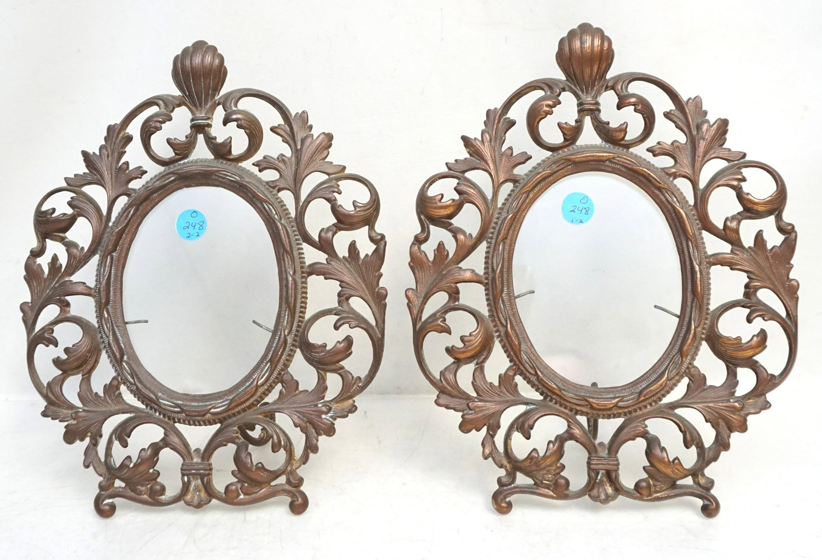 PAIR VICTORIAN GILDED FRAMES: Pair of Antique Victorian style Ornate Cast Iron Gilded Oval Table Picture Frame. Has 'XXX' Signed at the lower part of the frame and #08939 stamped at the left side of the back. The frames have swive